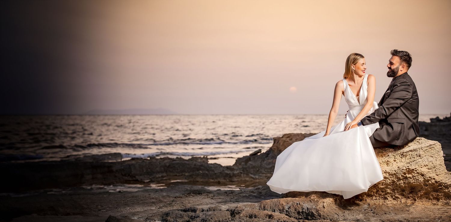 Sunset beach wedding photography session with couple walking along shoreline.