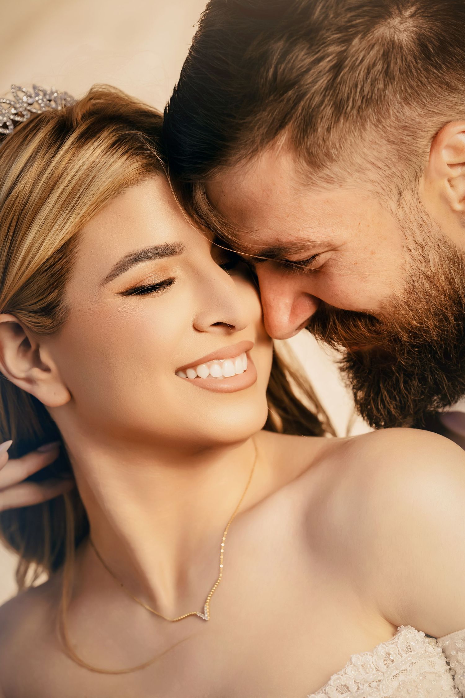Intimate close-up wedding portraits showing tender moments in warm natural lighting.