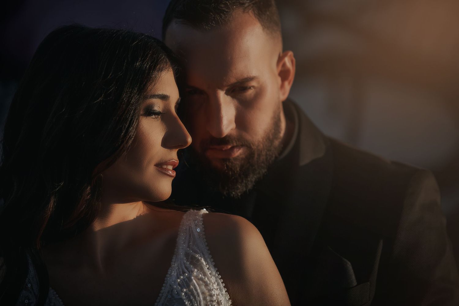 Intimate artistic portrait in dramatic low-key lighting.