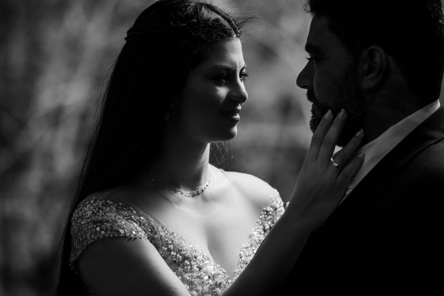 Romantic black and white wedding photography series showing intimate close-up moments between newlyweds.