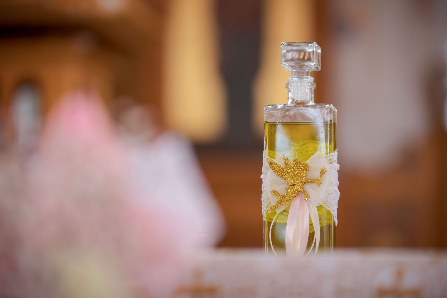 Decorative glass bottles with bows and floral embellishments.