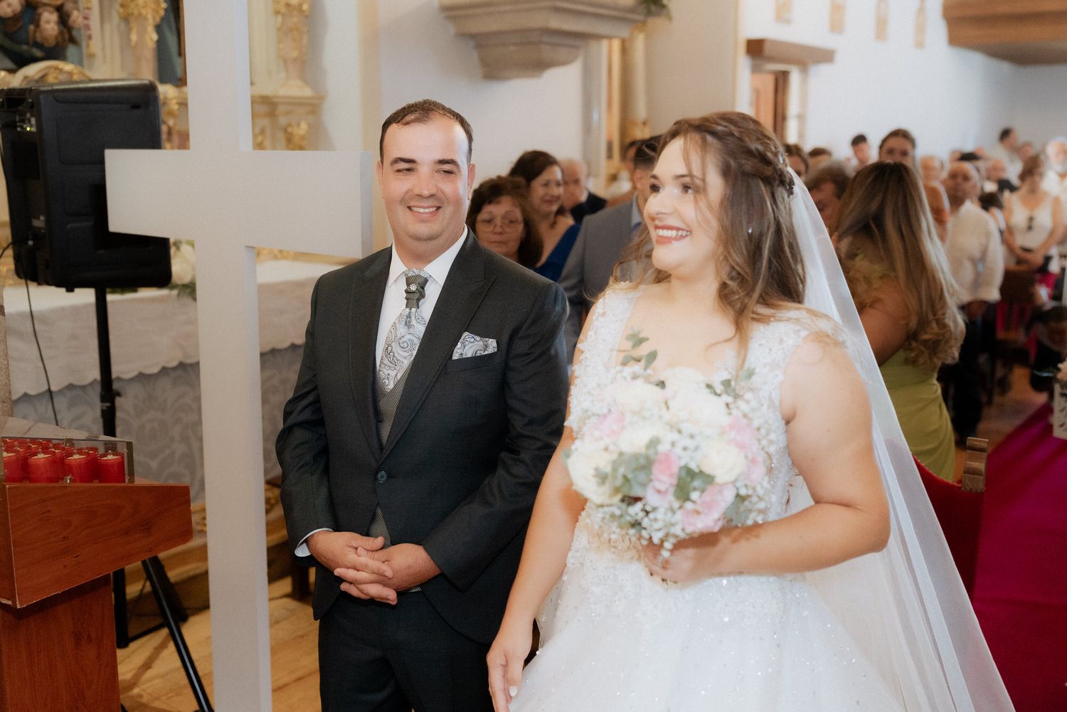 Joyful newlyweds laugh and celebrate during their traditional church wedding ceremony.