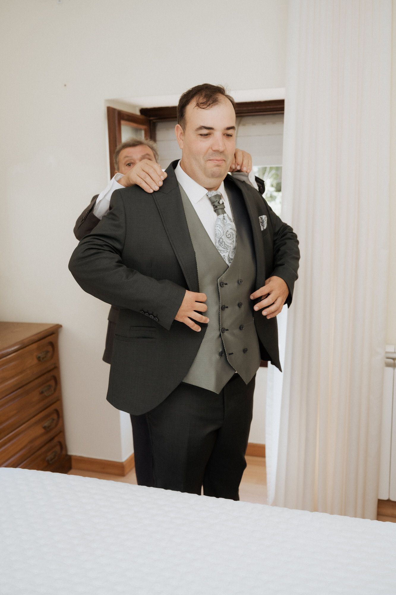 Two people in formal attire embrace in a series of emotional moments captured during a special occasion.