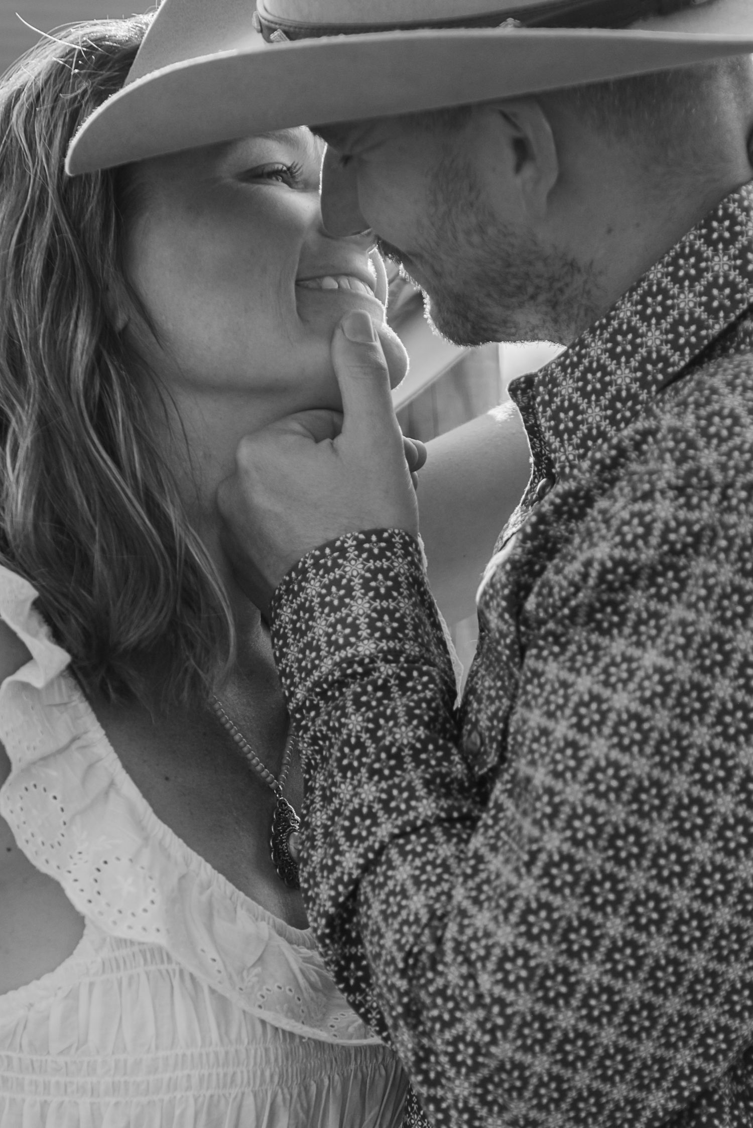 A romantic black and white photo series showing intimate close-up moments between a couple in vintage-style clothing.