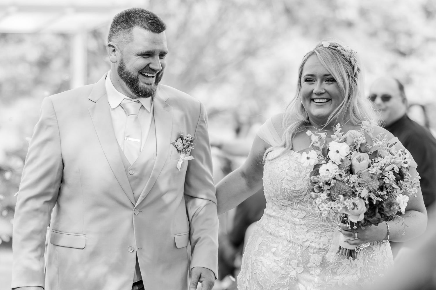 A black and white photo series showing joyful moments from an outdoor wedding ceremony.
