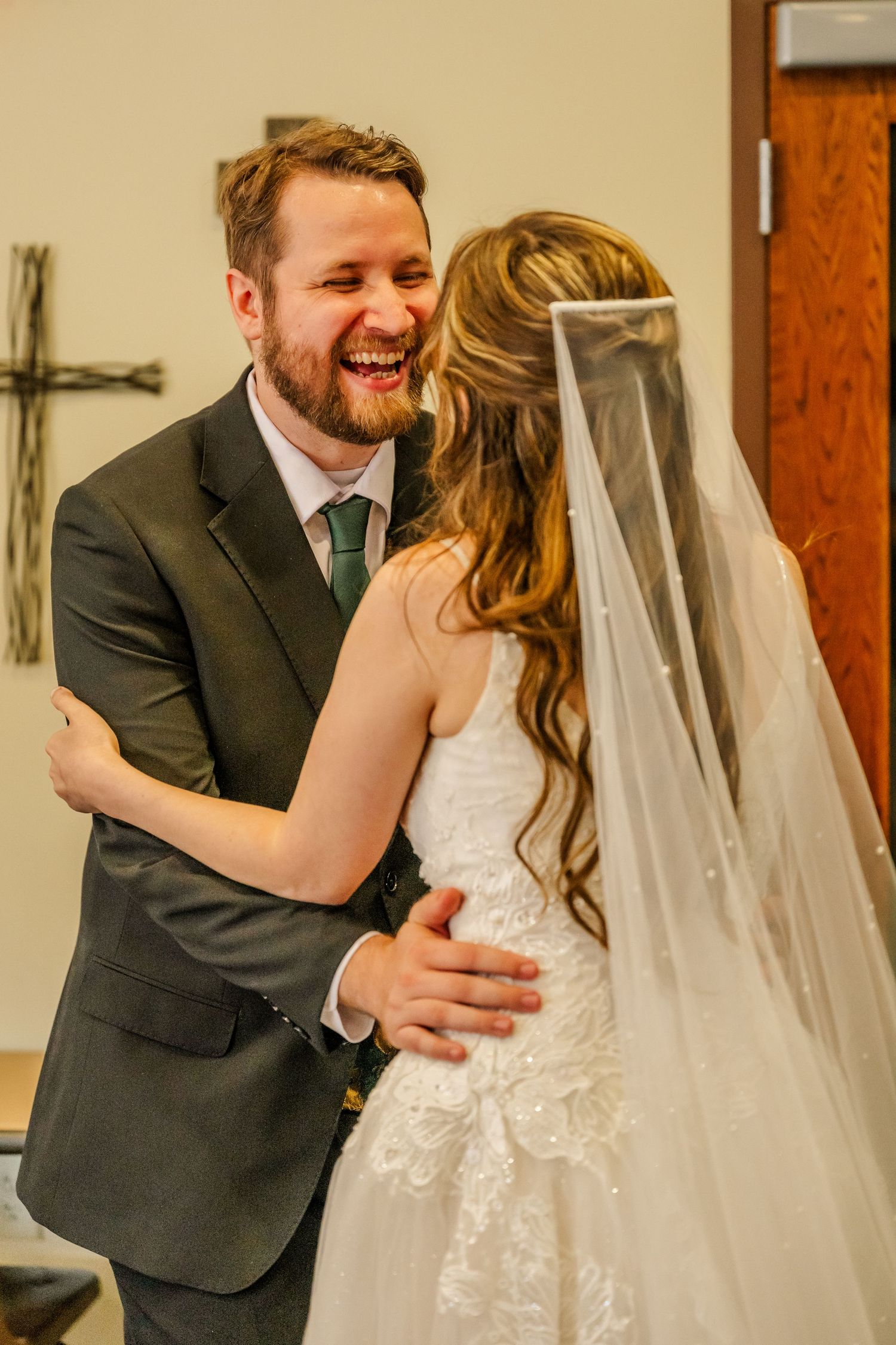 Joyful wedding moment captured in an indoor venue with elegant decor.