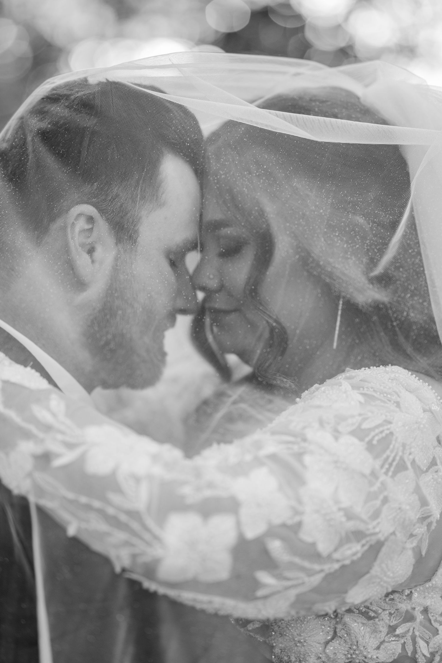 Romantic black and white veil shot of newlyweds sharing an intimate moment.Four Seasons Barn Wedding & Event Venue