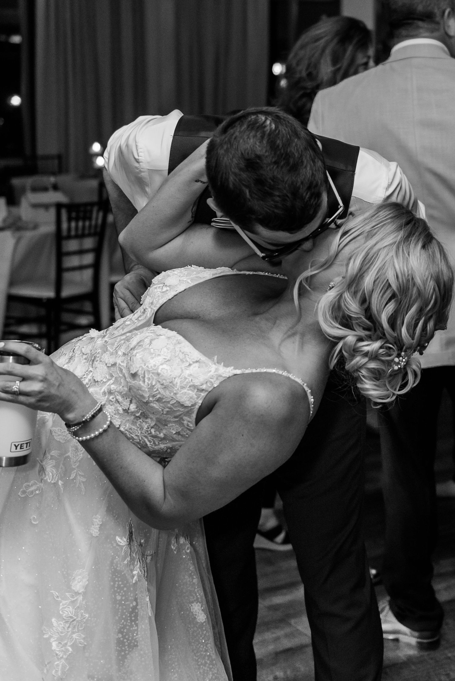 A romantic black and white photo of a couple sharing an intimate dance moment at their wedding reception.