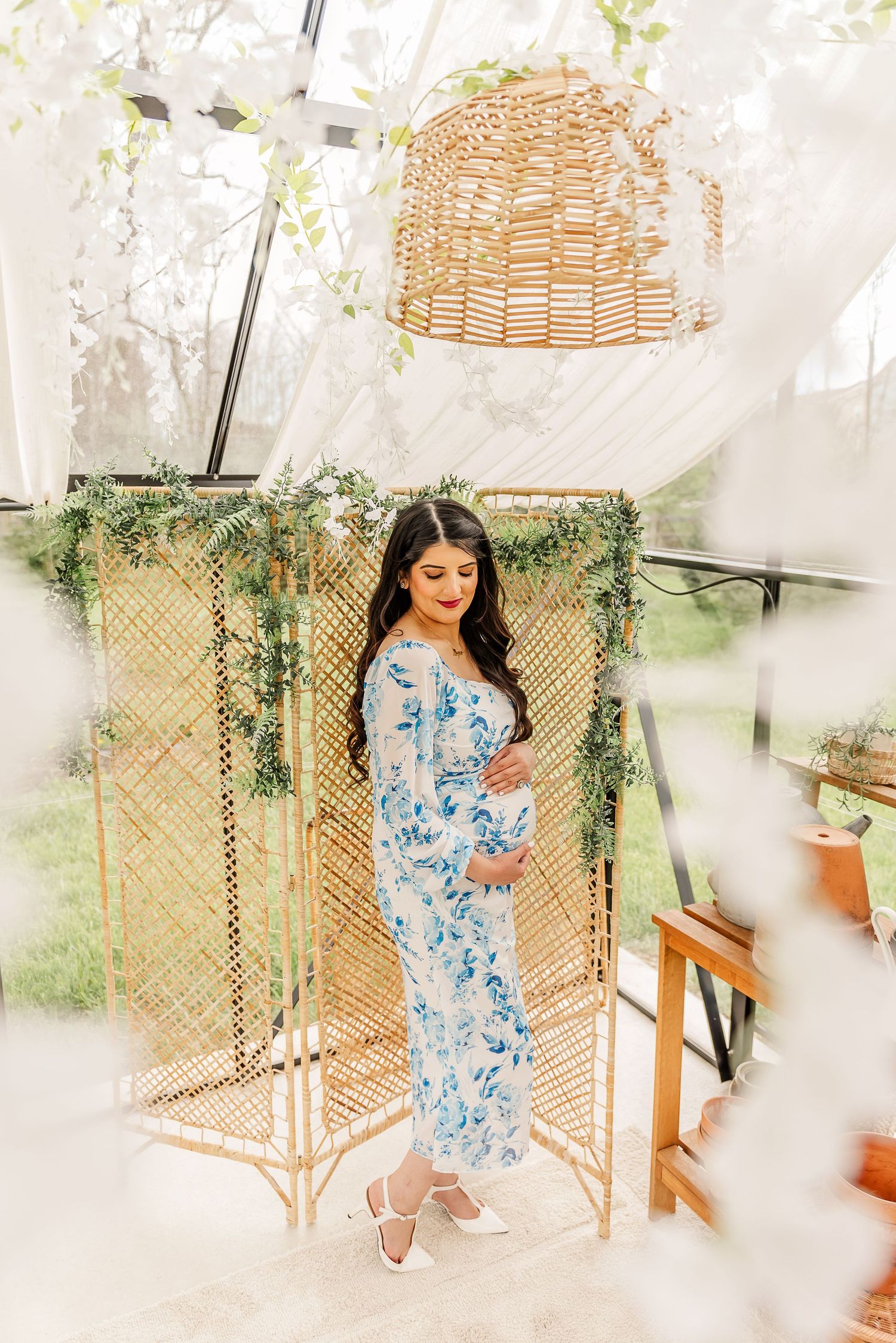 A light-filled indoor space with rattan decor and hanging greenery creates a boho atmosphere.