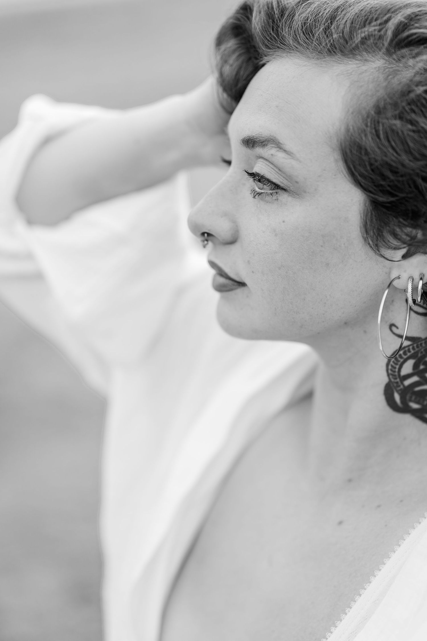 Close up black and white portrait series showing a woman's side profile in joyful expressions.