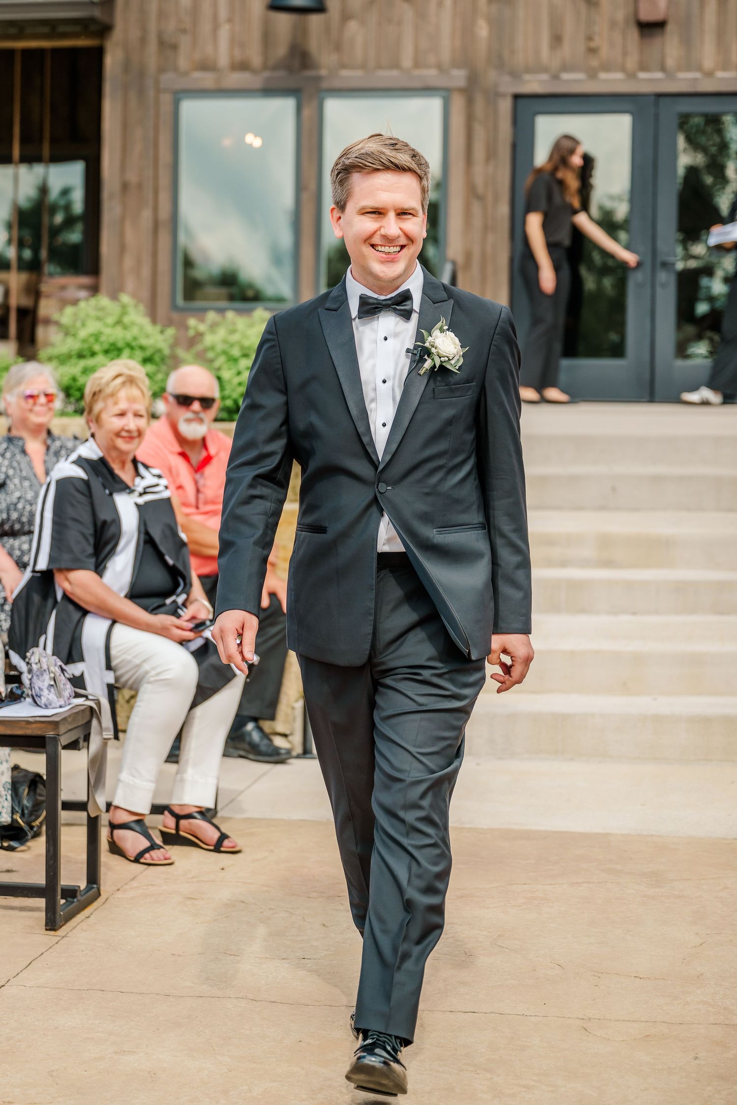Wedding ceremony setup with guests seated on wooden benches facing a rustic wooden altar.The Old Barns at Dry Run Farms in Williamsport, OH.