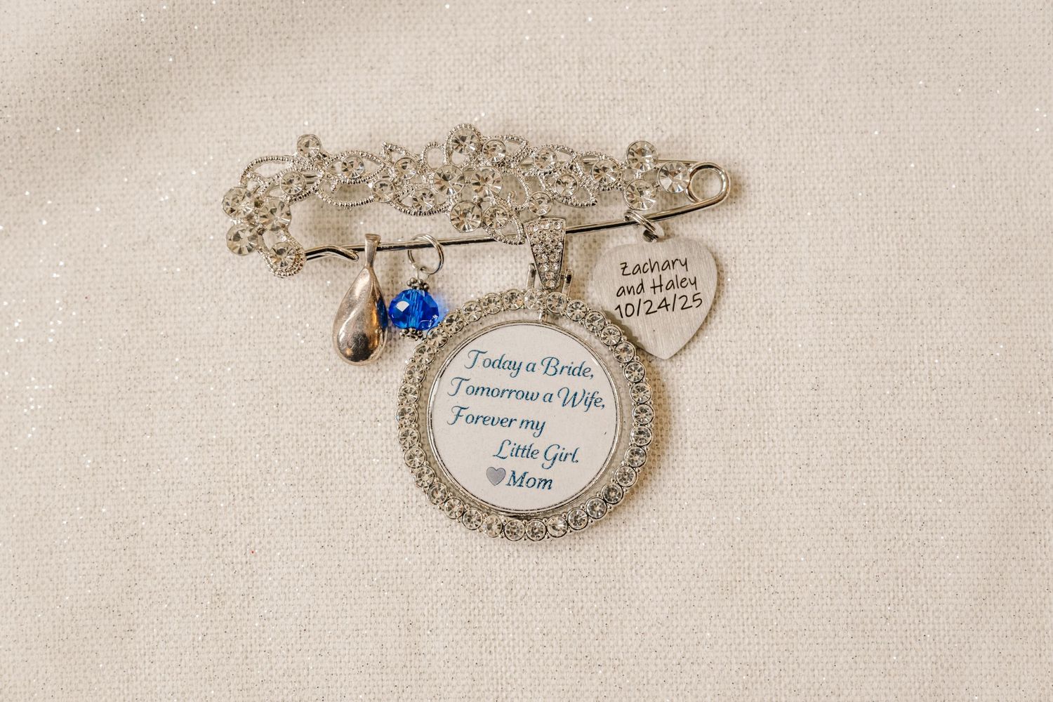Delicate silver filigree jewelry pieces with ornate details and blue gemstone accents displayed on a light background.