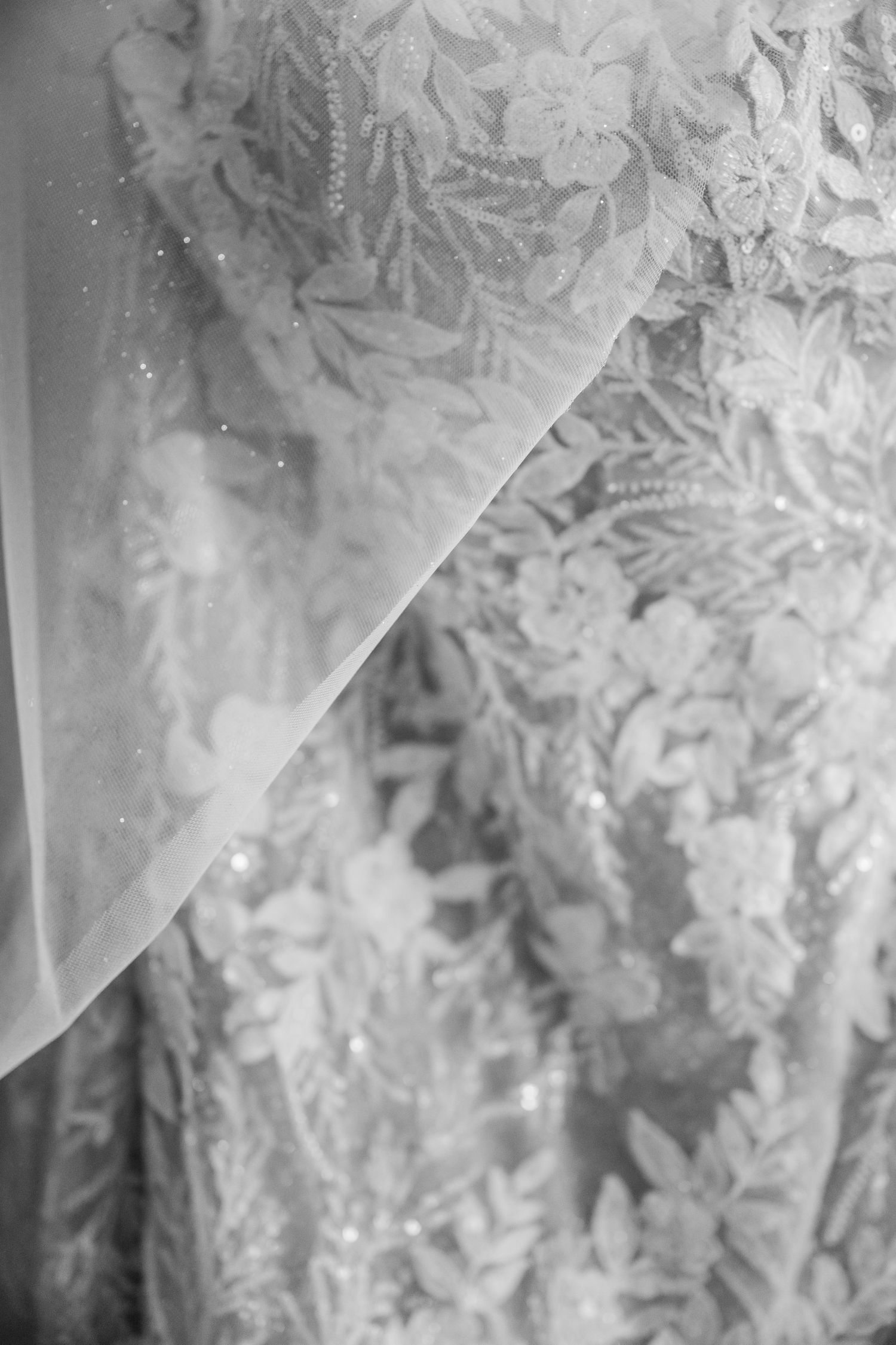 Close-up view of delicate frost crystals forming intricate patterns on a glass window surface in winter.