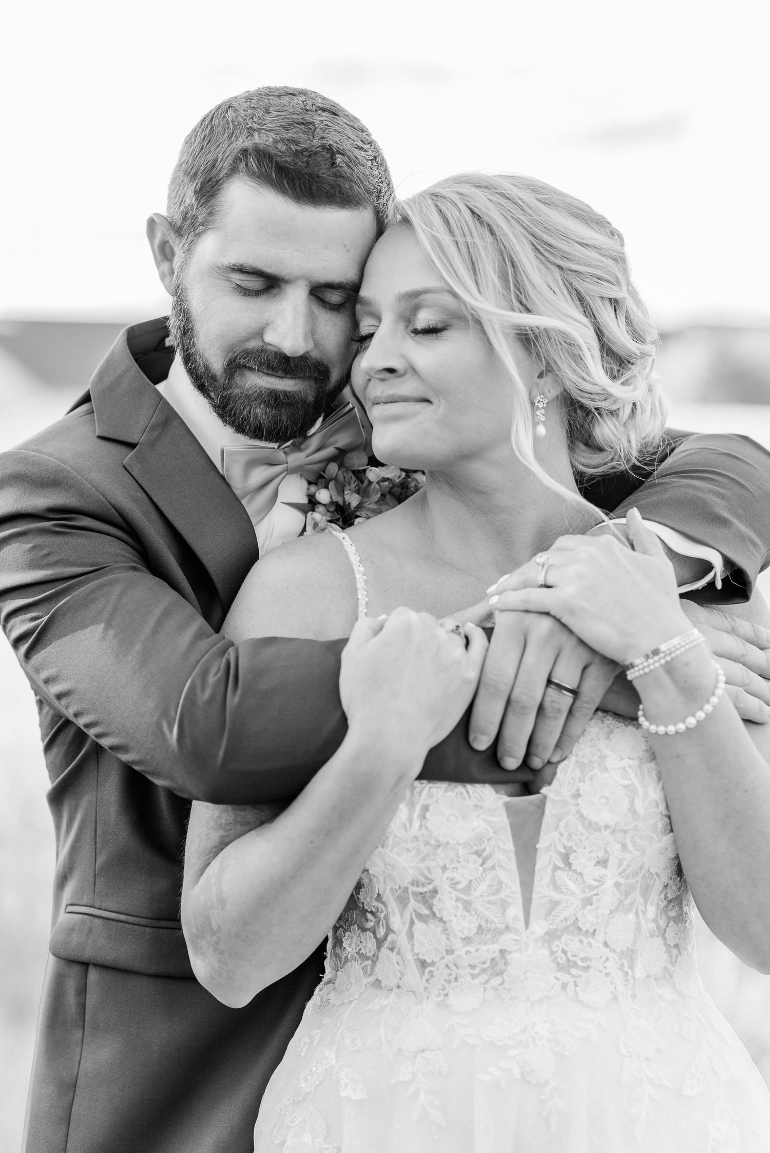 A series of intimate black and white wedding photos showing tender moments between a couple.