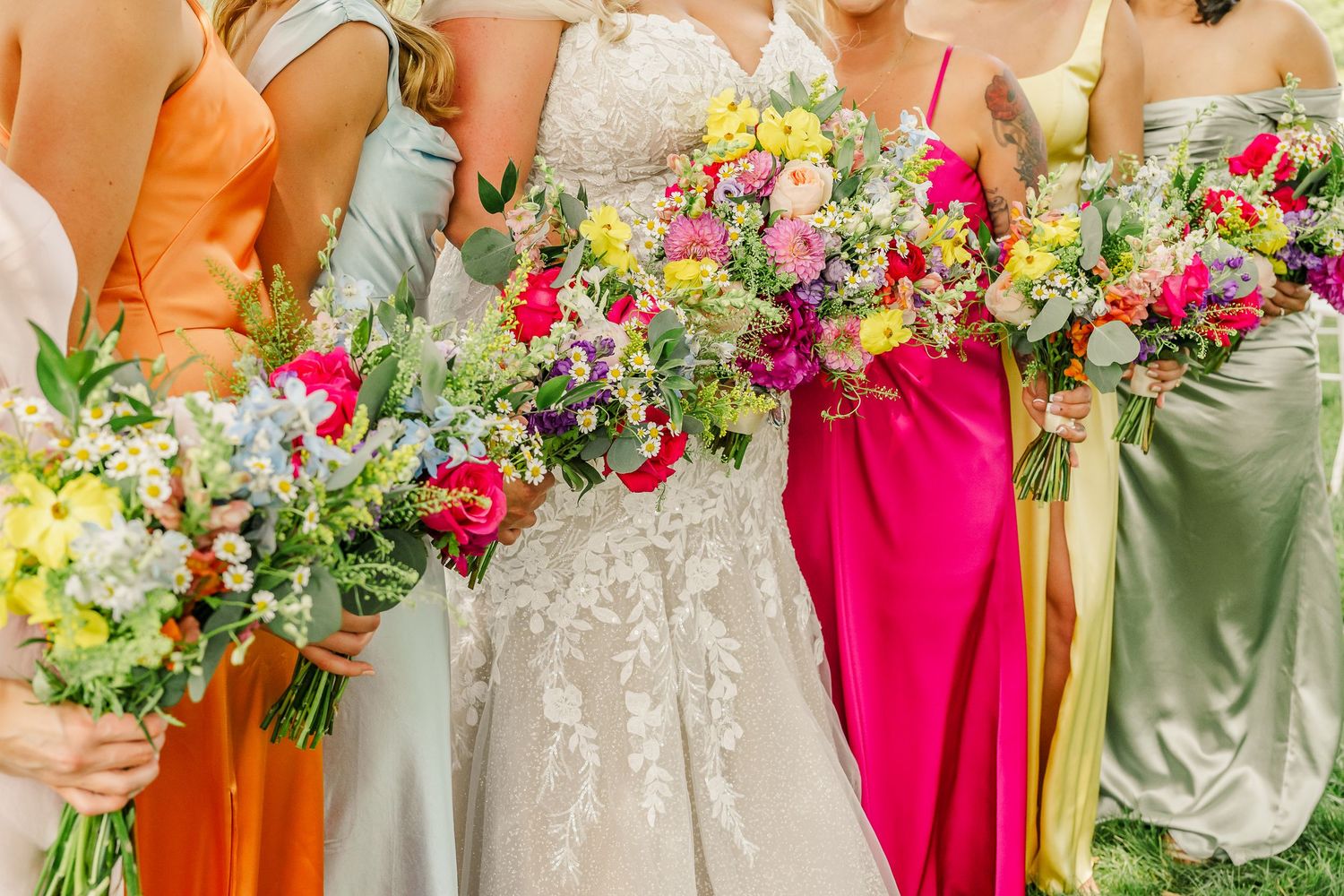 Colorful bouquets of pink, yellow and purple flowers held against formal dresses in orange, green and fuchsia tones.