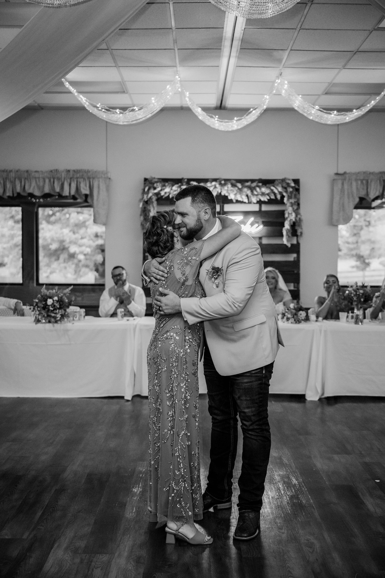 Black and white sequence of dance photos showing a couple sharing a romantic slow dance at a wedding reception.
