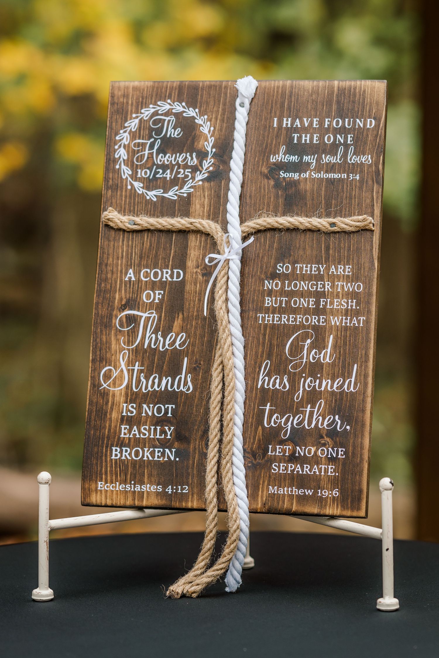 Wooden signs with rope cord display biblical wedding ceremony text about three strands and God joining together.