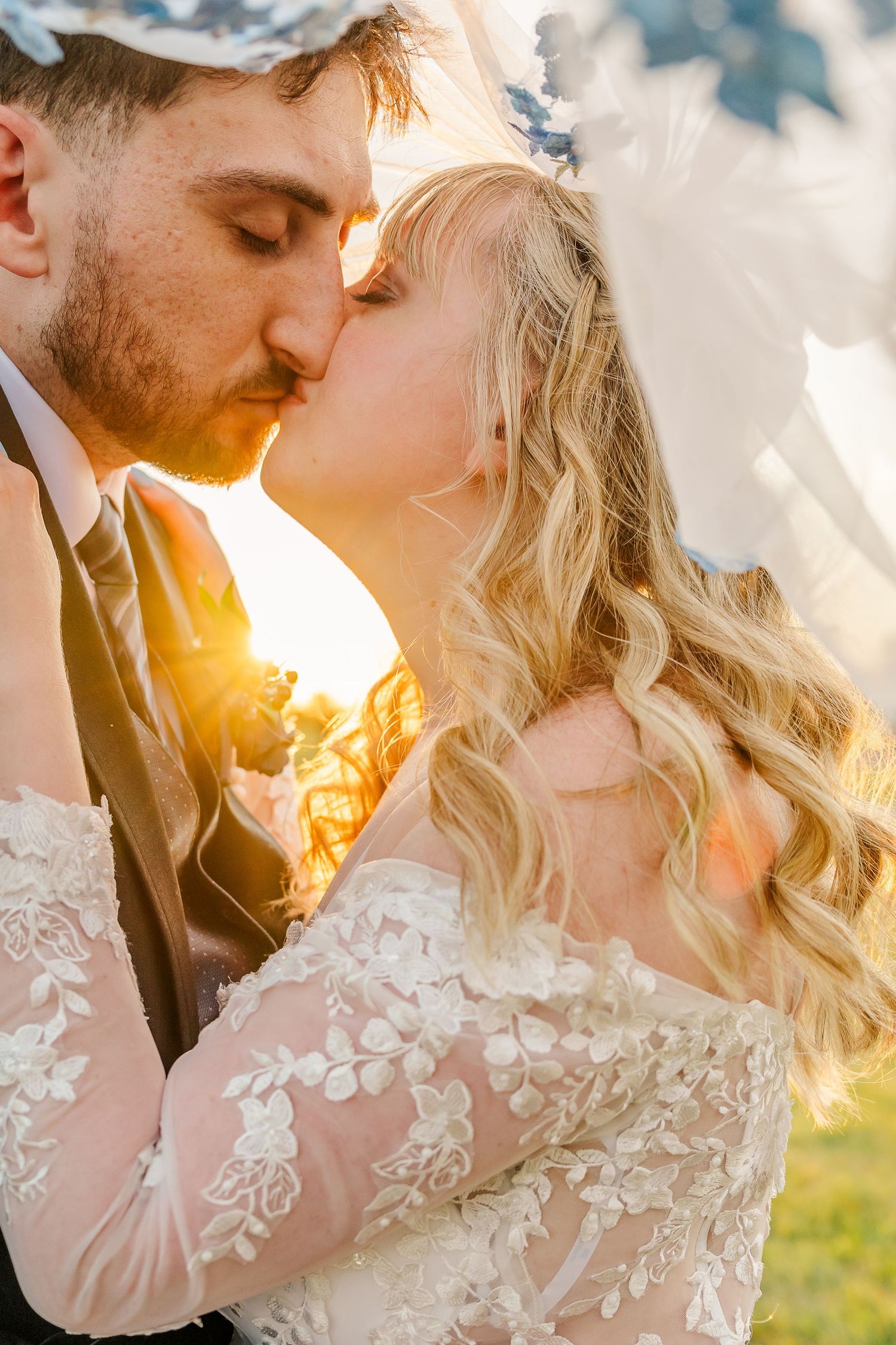 Romantic sunset wedding photoshoot featuring a close-up of a couple in a lace gown.