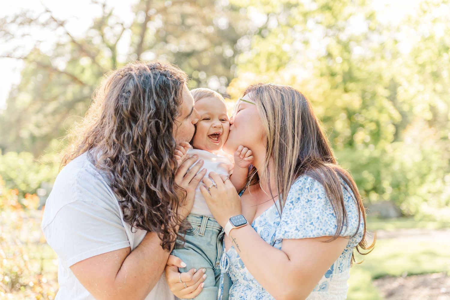 Intimate family portraits showing tender moments between parent and child outdoors.