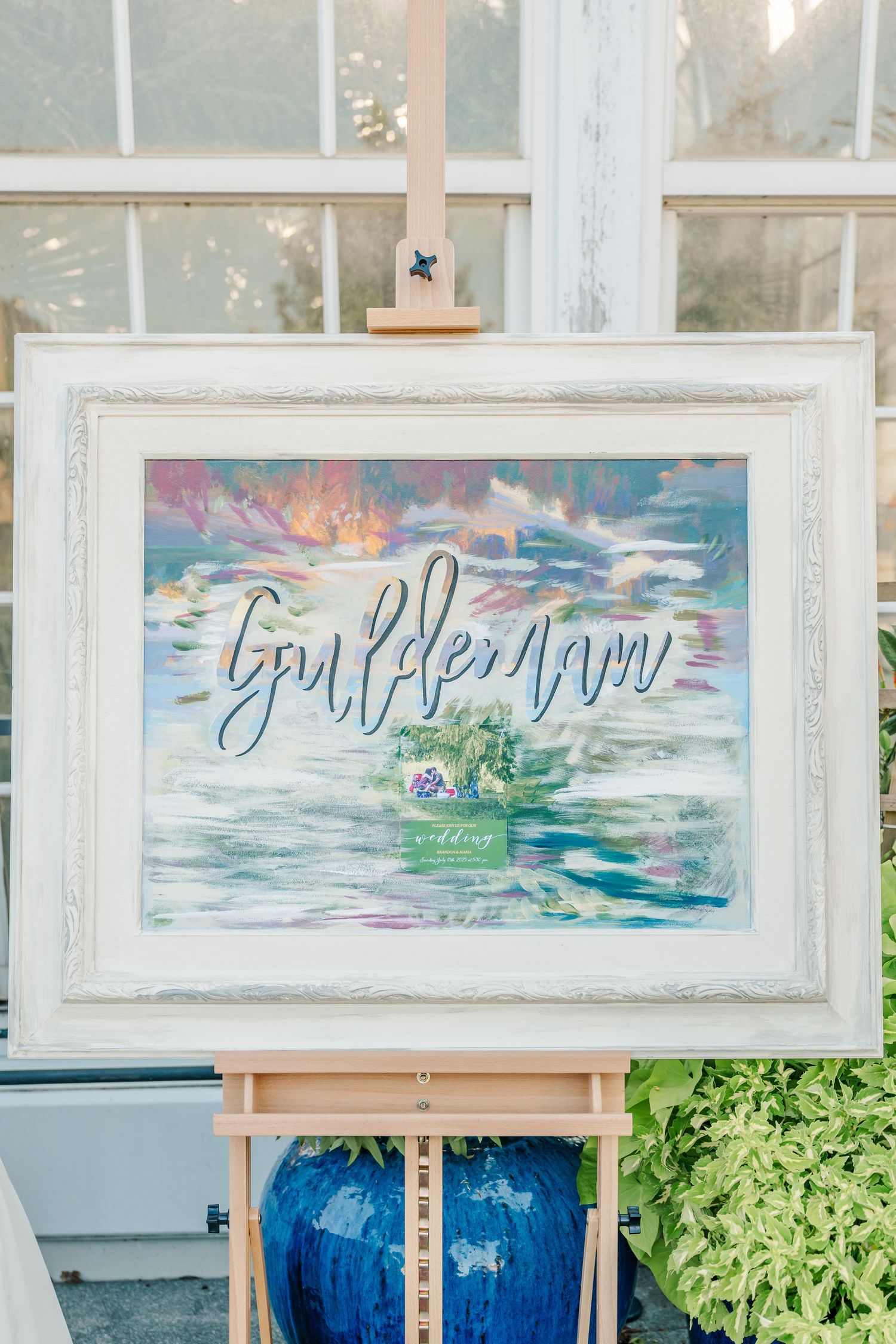 Watercolor artwork displayed in white frames against a rustic wall with blue decor beneath.