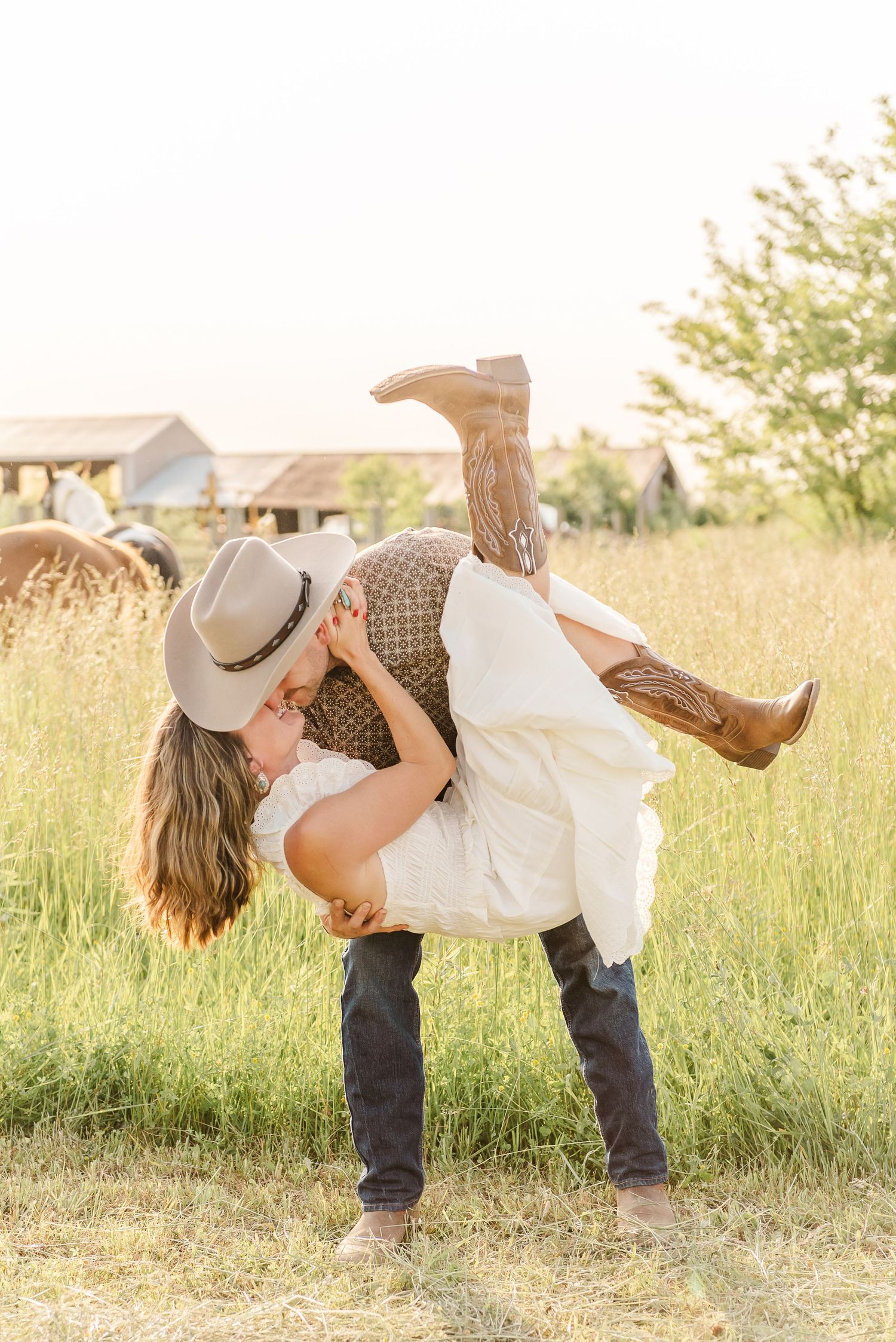 A playful dance sequence shows a couple twirling in a golden field at sunset.