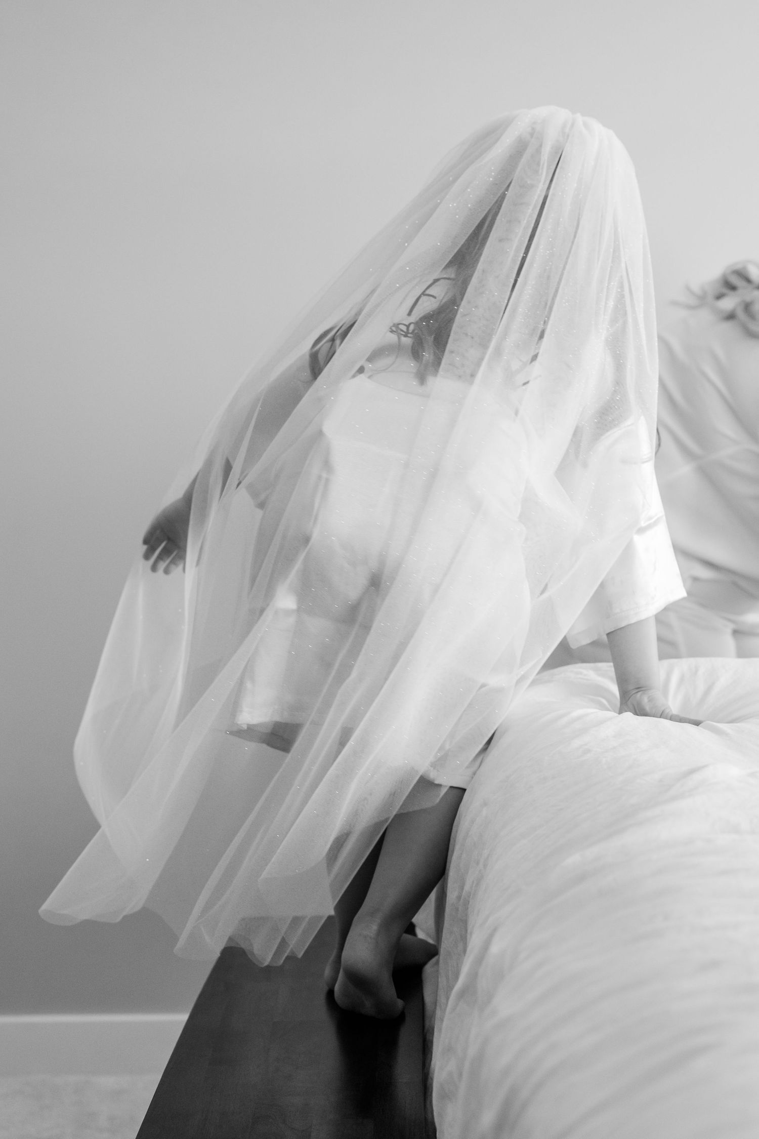 Artistic black and white photo series showing flowing white veils creating ethereal movement against a light background.
