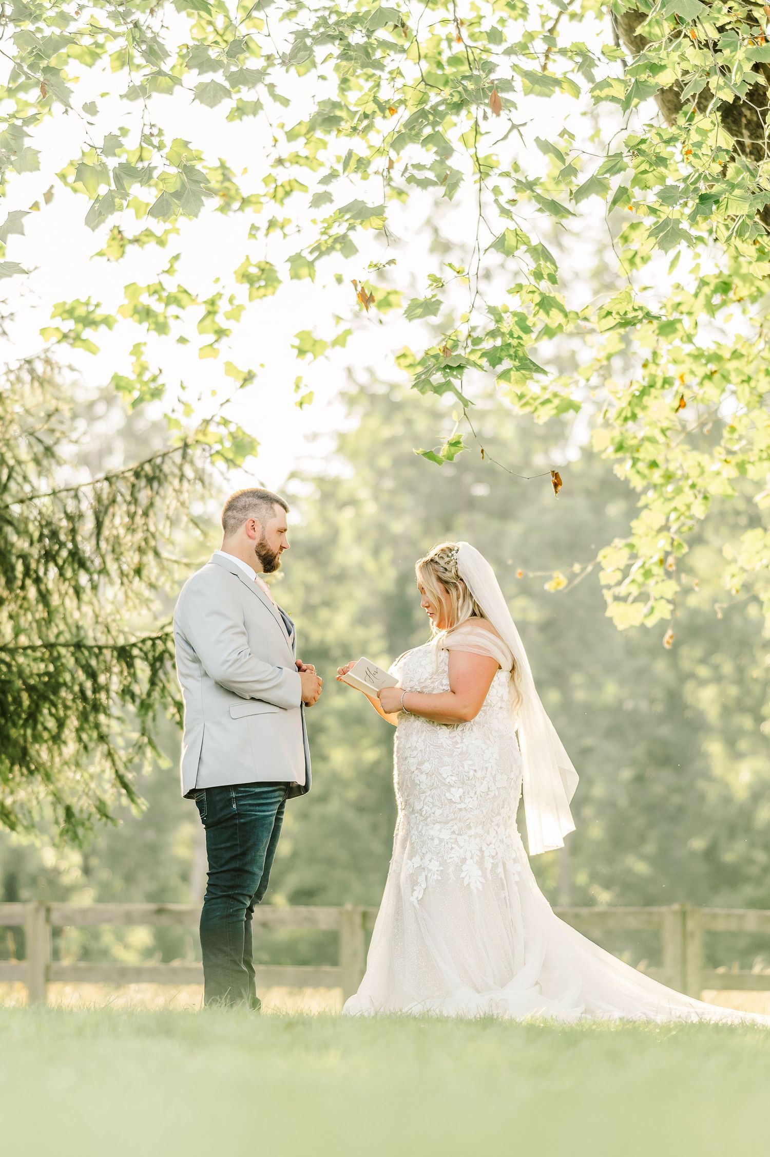 A bride and groom share a romantic moment in a sunlit garden during their wedding day.