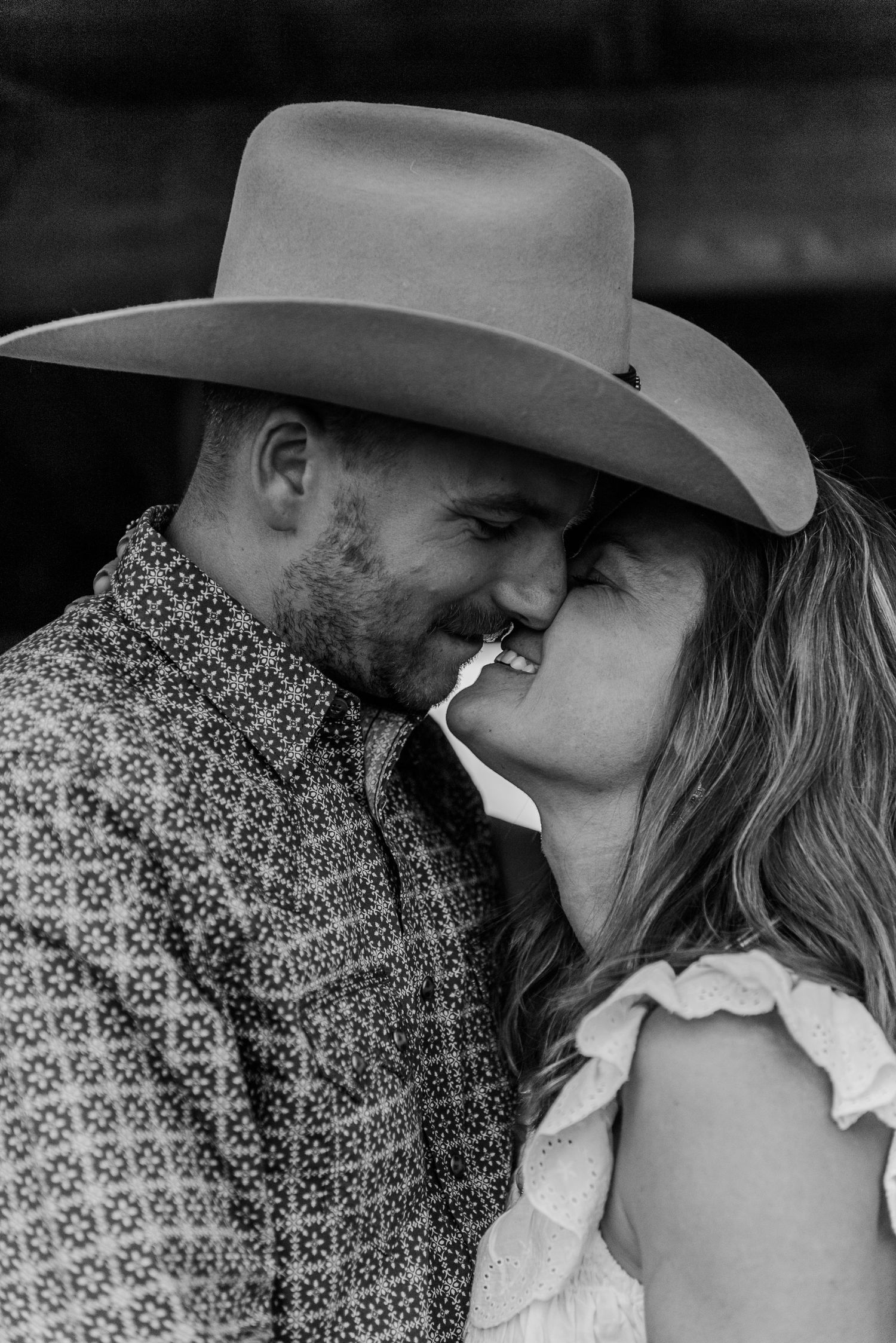Close up black and white series capturing romantic moments between a couple in western wear.