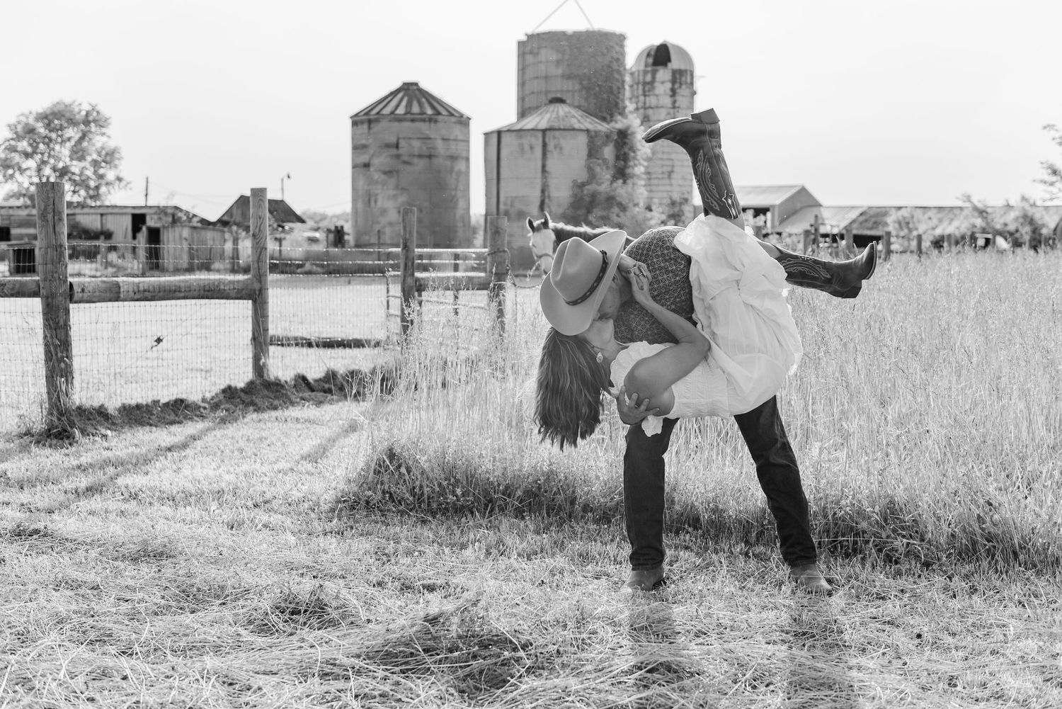 A black and white photo collage shows five romantic scenes of a couple embracing in a rustic outdoor setting.