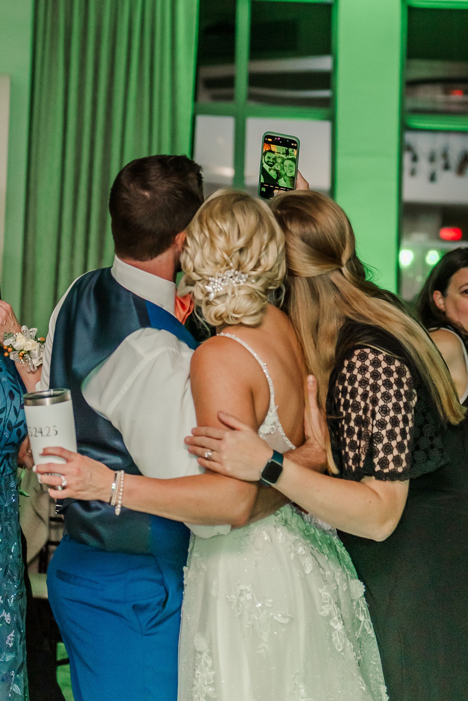 Wedding reception dance photos with green lighting showing couples embracing on the dance floor.