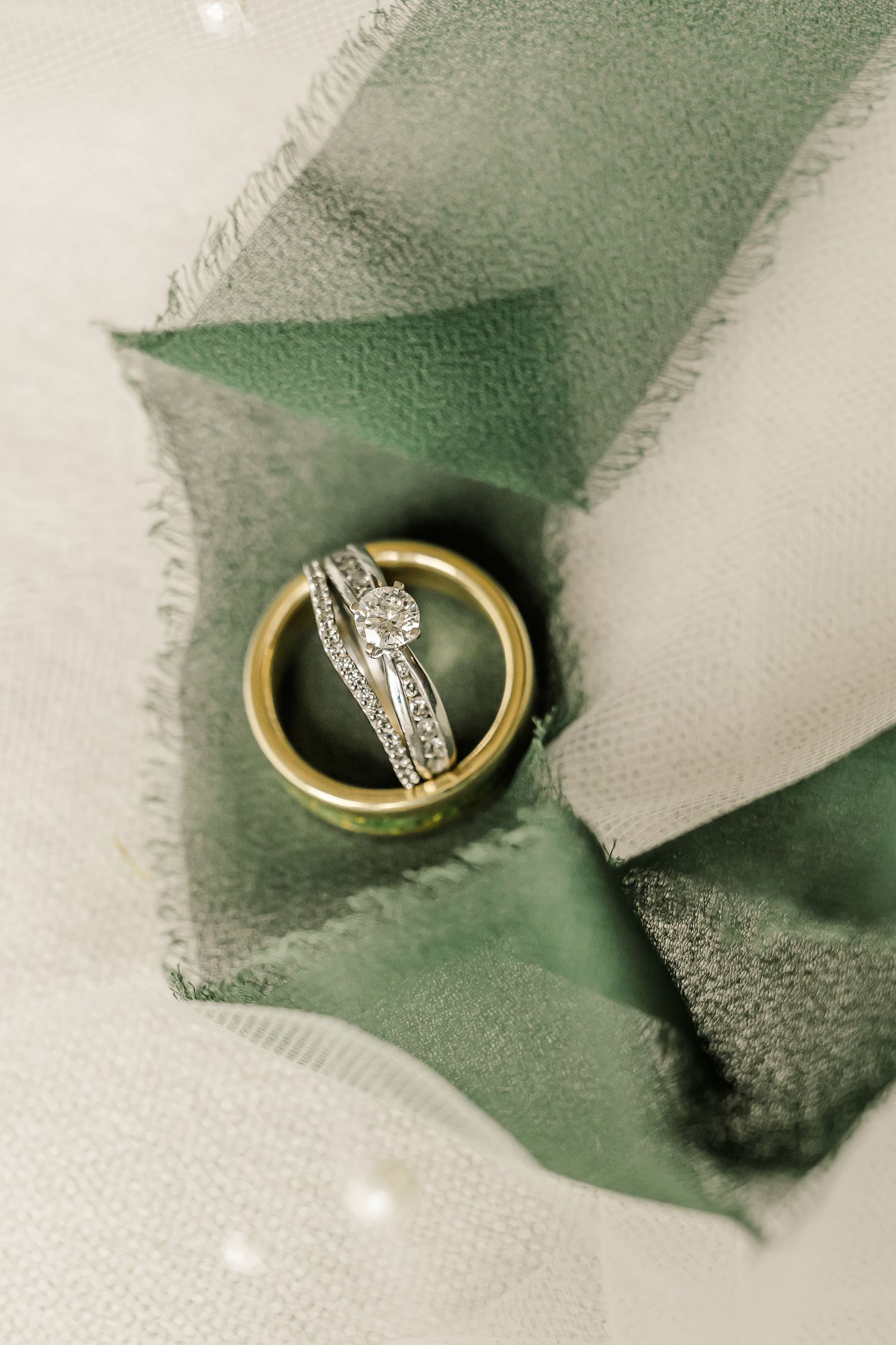 A gold wedding ring with diamonds set in an elegant band shown in a sequence against a green and white background.