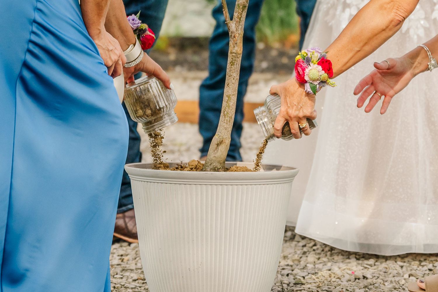 A series of wedding photos showing hands pouring sand into a unity ceremony vessel during an outdoor celebration.