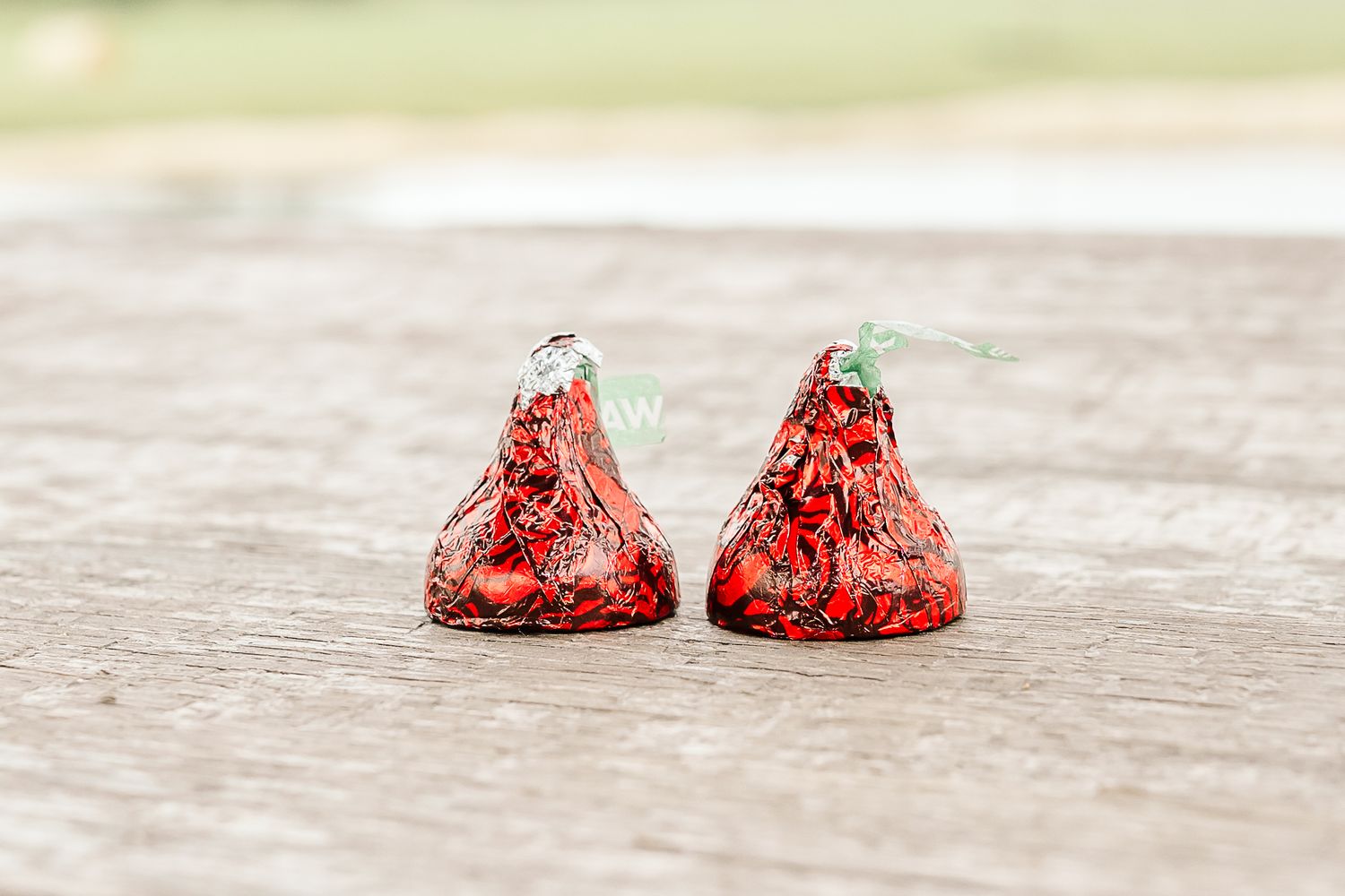 A sequence of photos showing red strawberry candy dissolving in water over time, creating a fading effect.