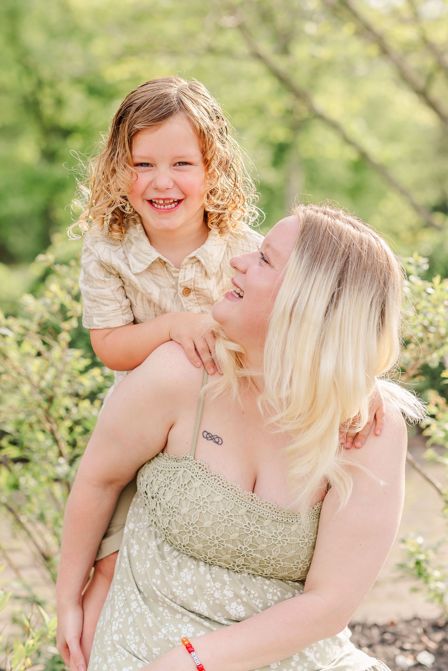 Mother and daughter sharing affectionate moments during outdoor portrait session in spring.