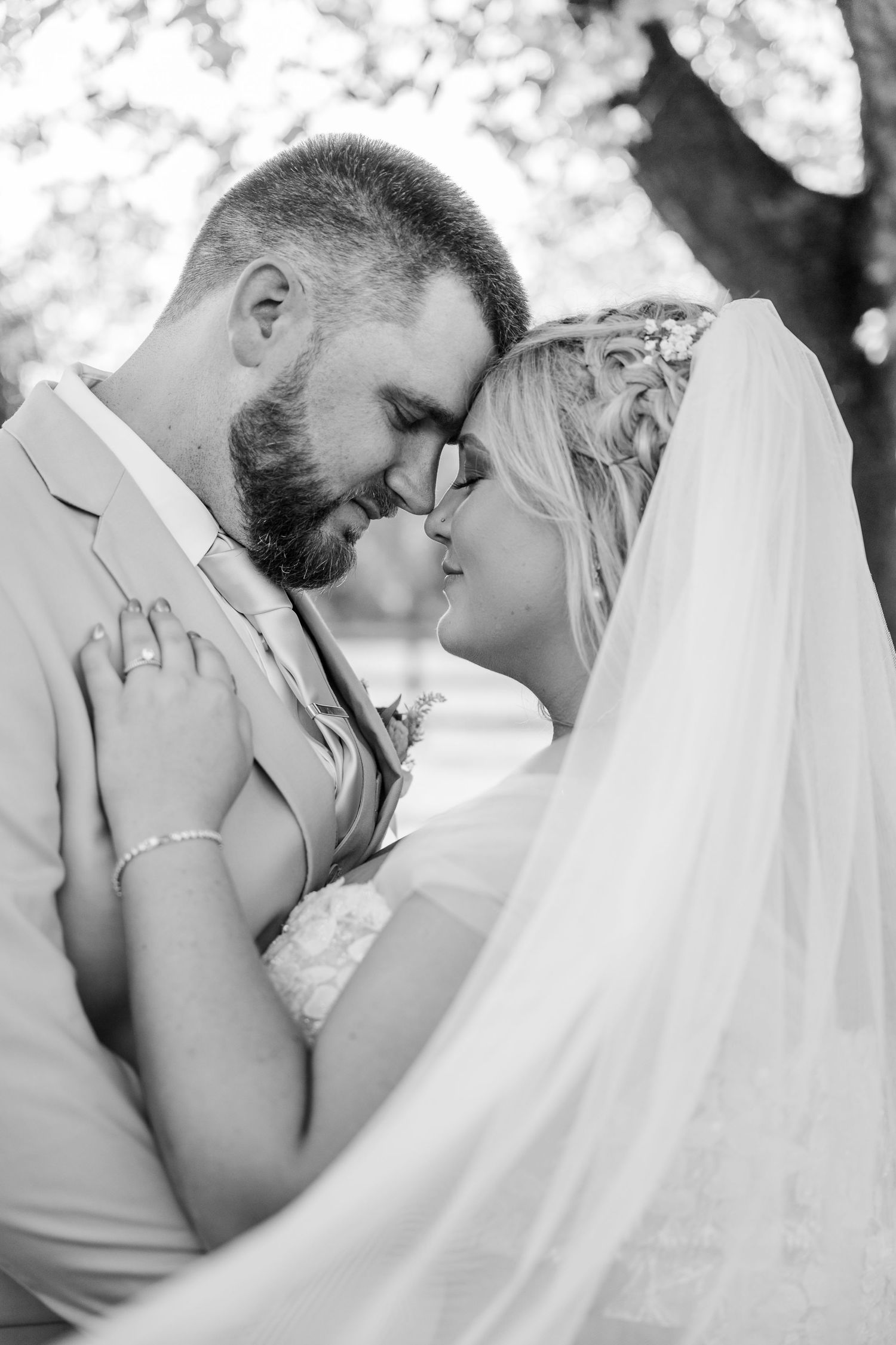 Intimate black and white wedding portraits capturing romantic moments between newlyweds.