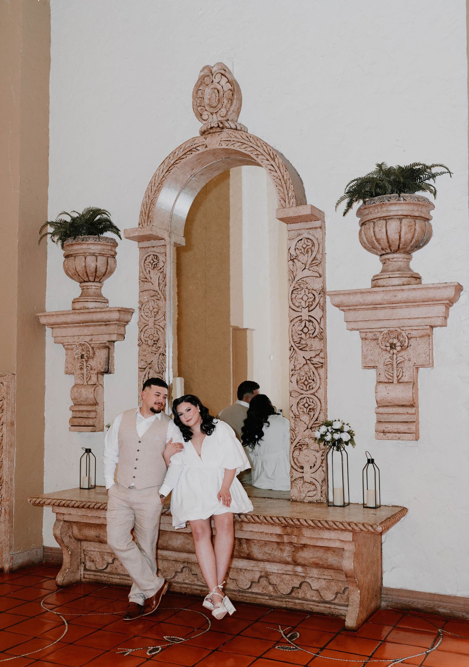 Romantic sequence of poses on decorative stone benches with carved details.