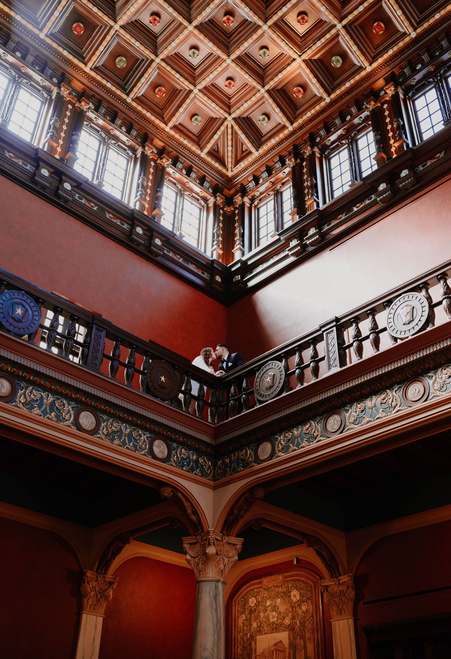 An ornate wooden coffered ceiling with intricate details in a historic building interior.