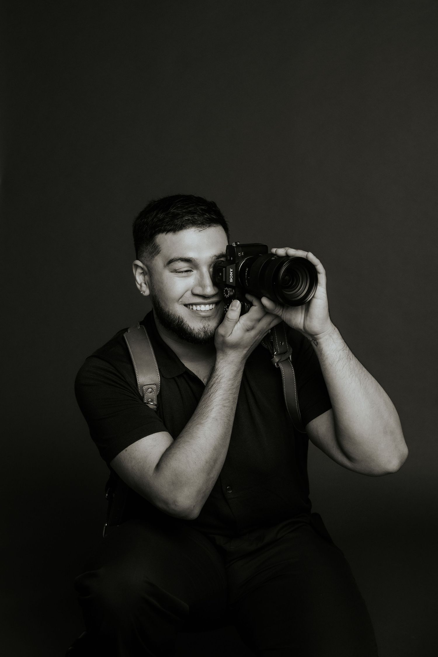 Black and white photo series showing emotional expressions with hands covering face against dark background.