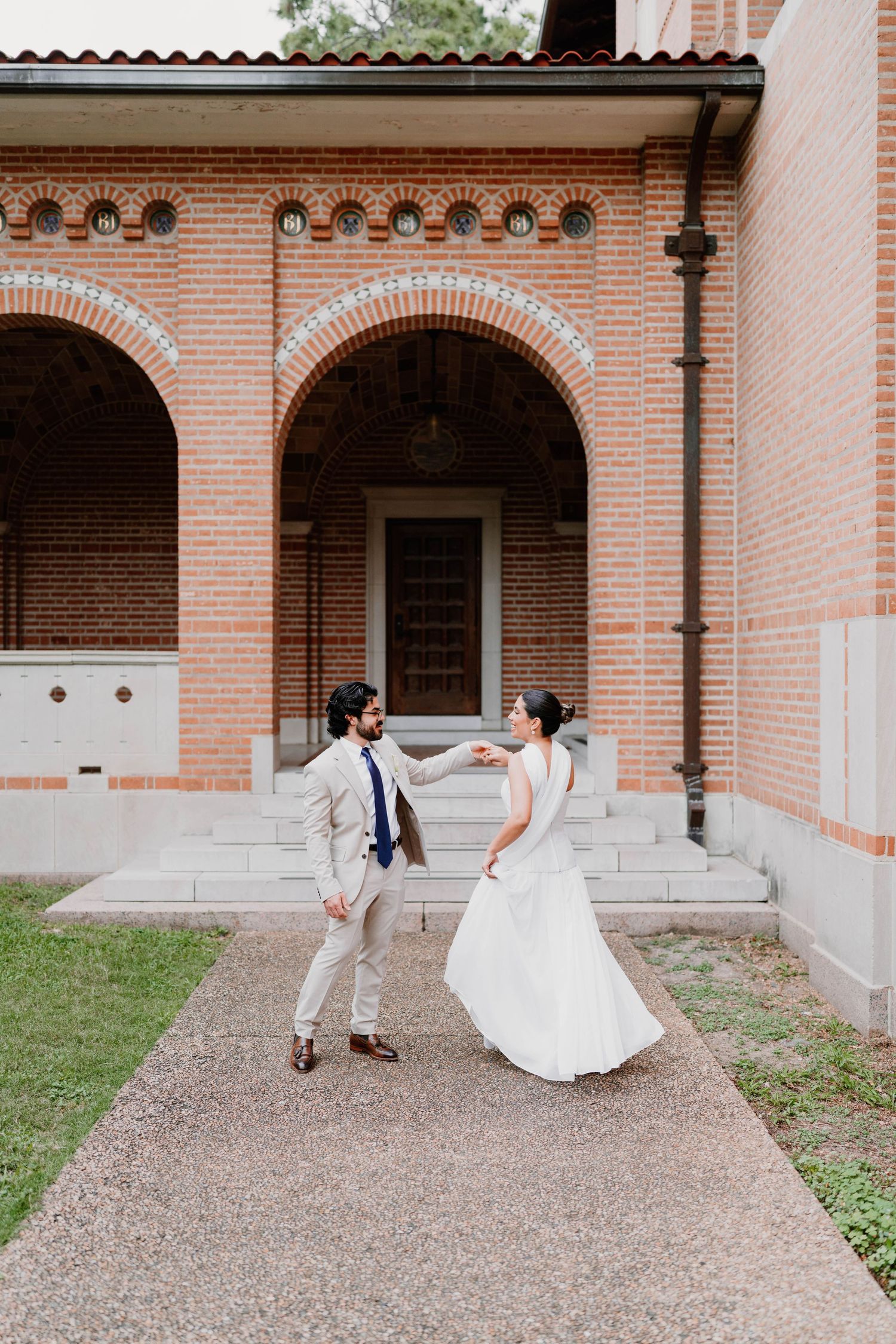 Playful wedding photo sequence under brick archways with spinning dress movements.