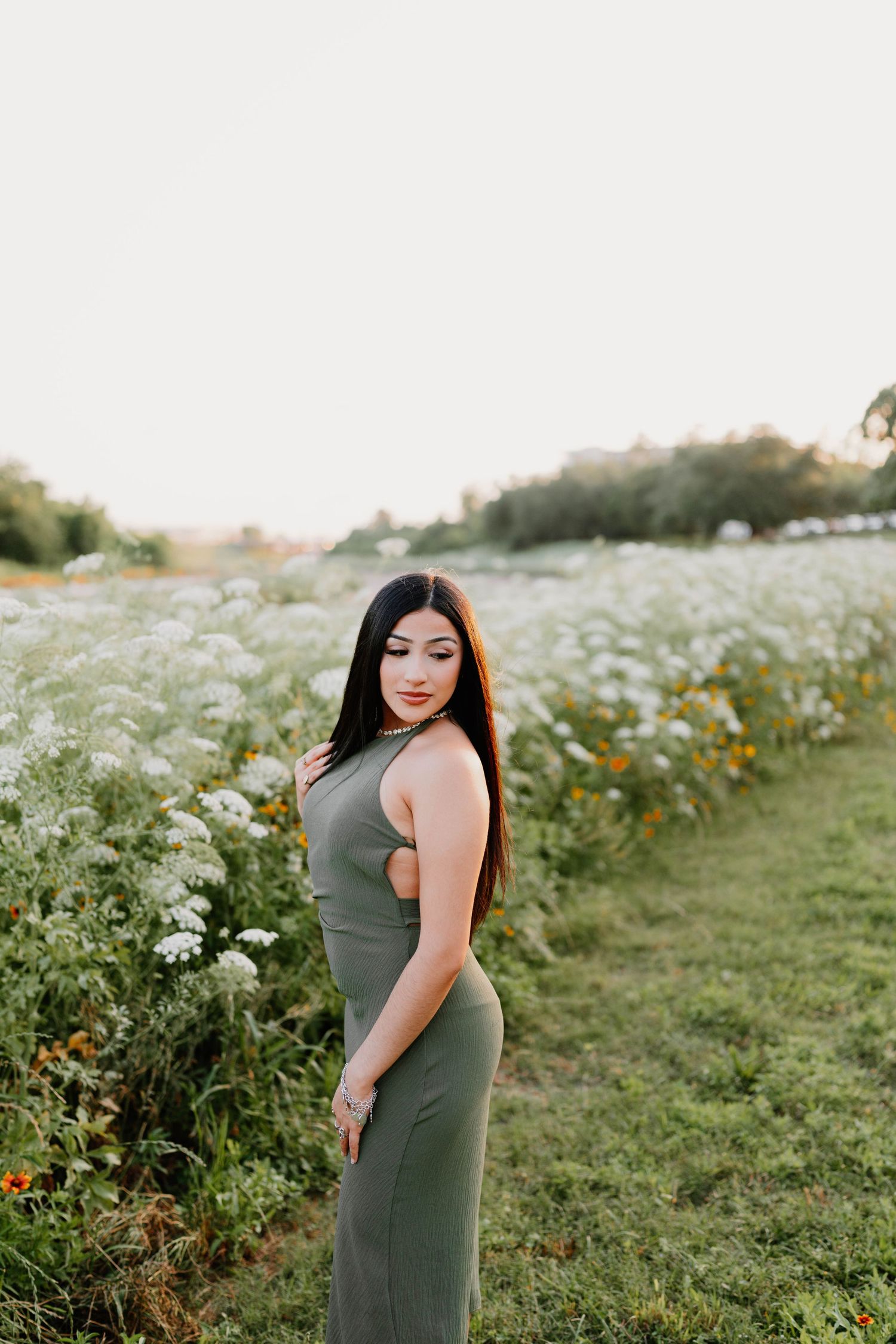 Outdoor portrait session in a wildflower field with olive green dress.