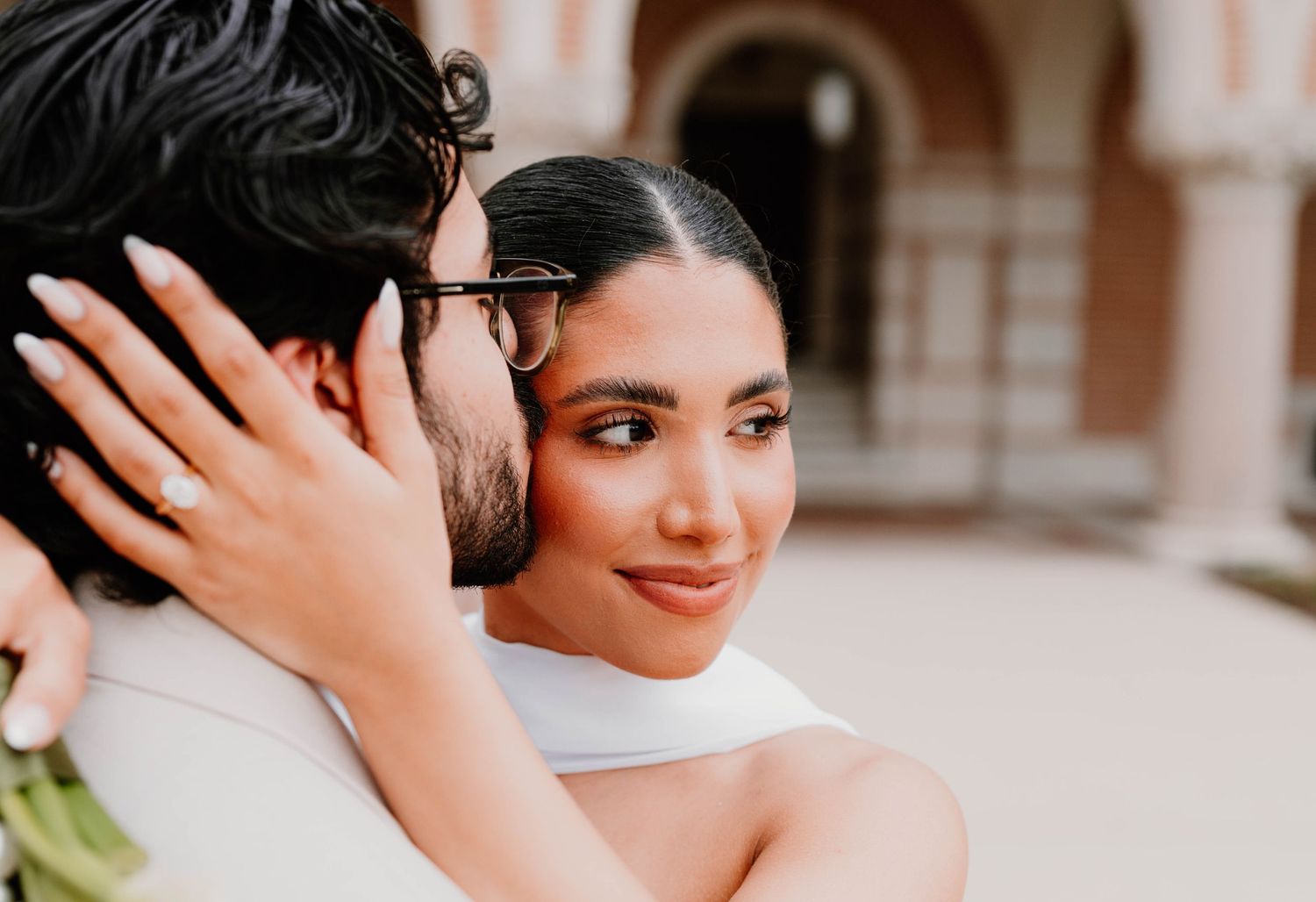 Intimate outdoor wedding moment captured in warm evening light.