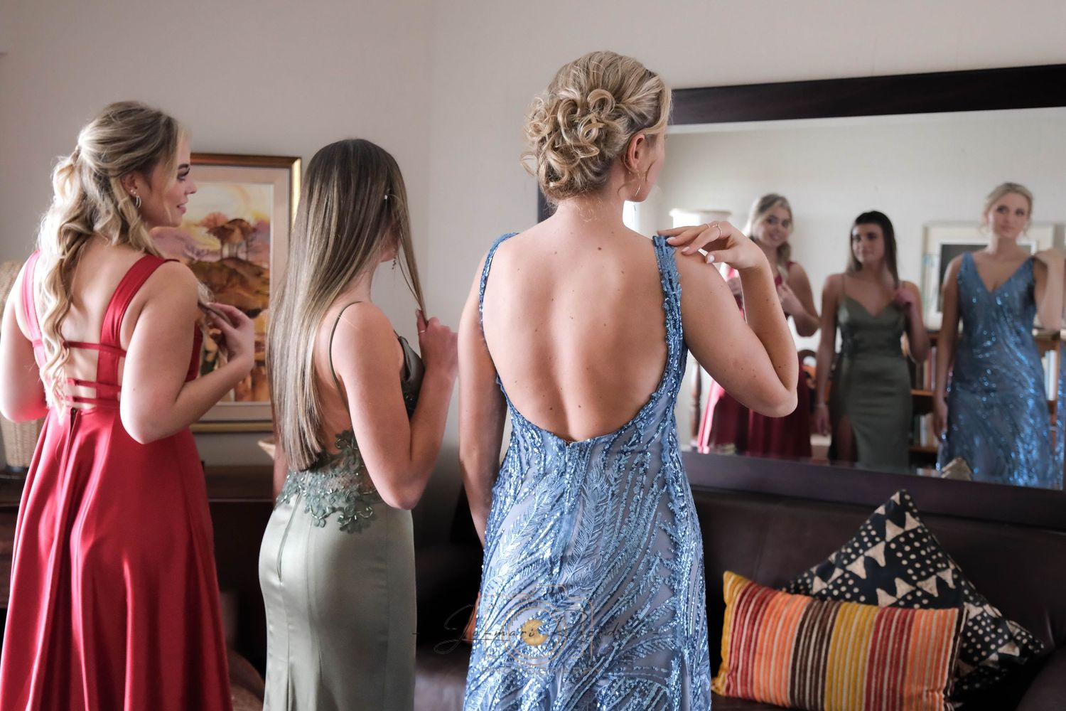 A formal gathering with people in elegant dresses preparing for an event.