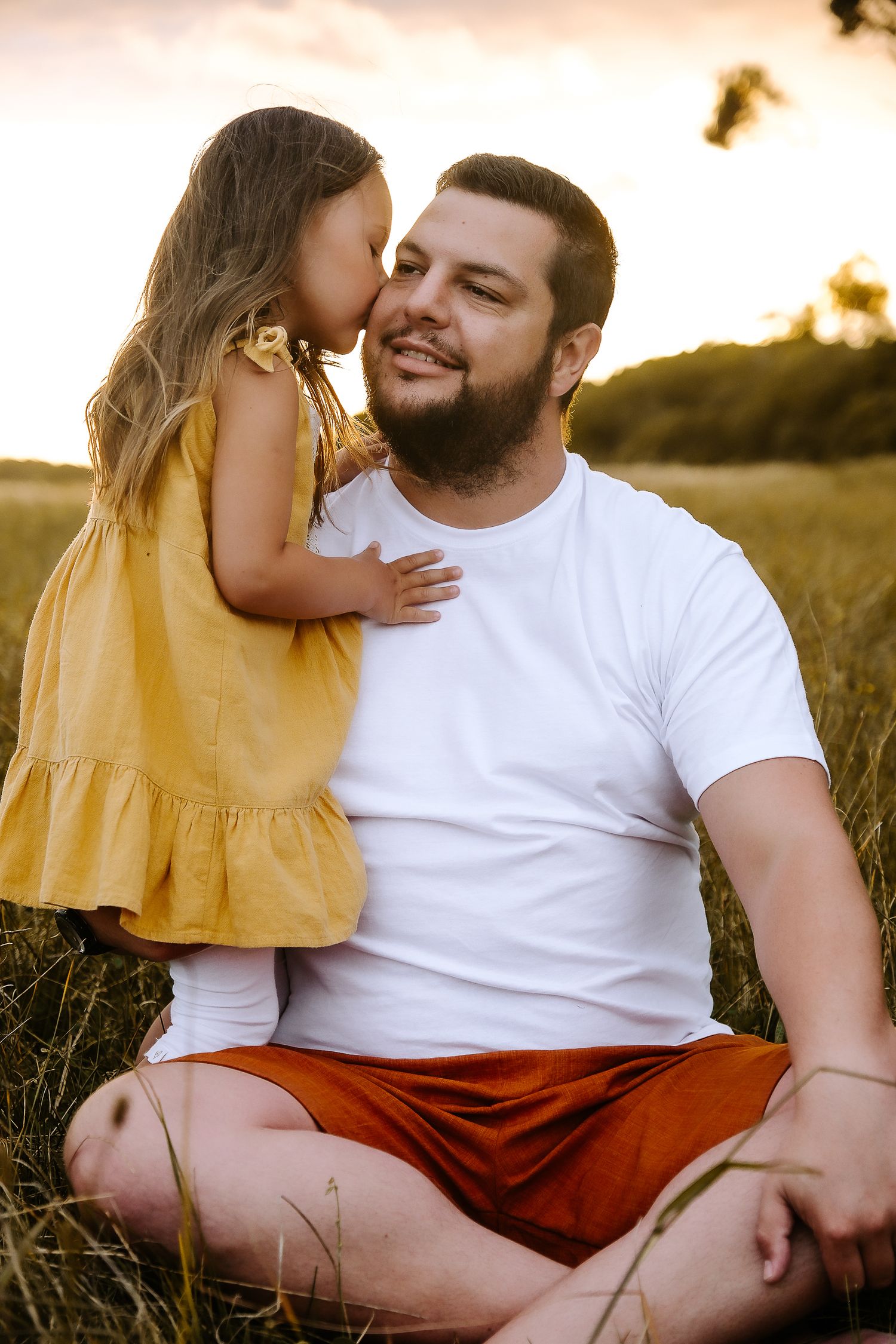 Sweet moment between parent and child in a sunny field.