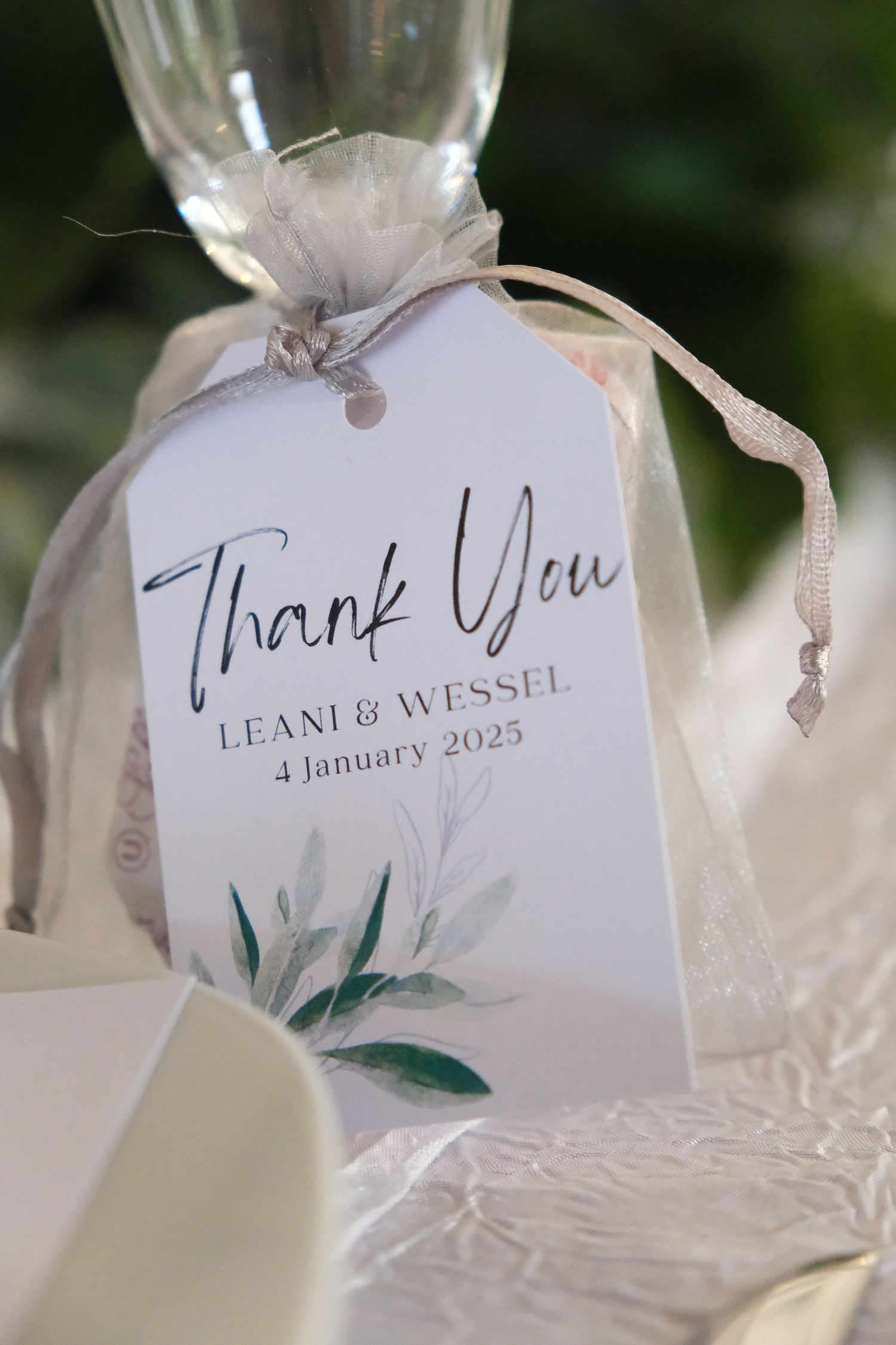 Elegant wedding favor tag with greenery design and 'Thank You' text.
