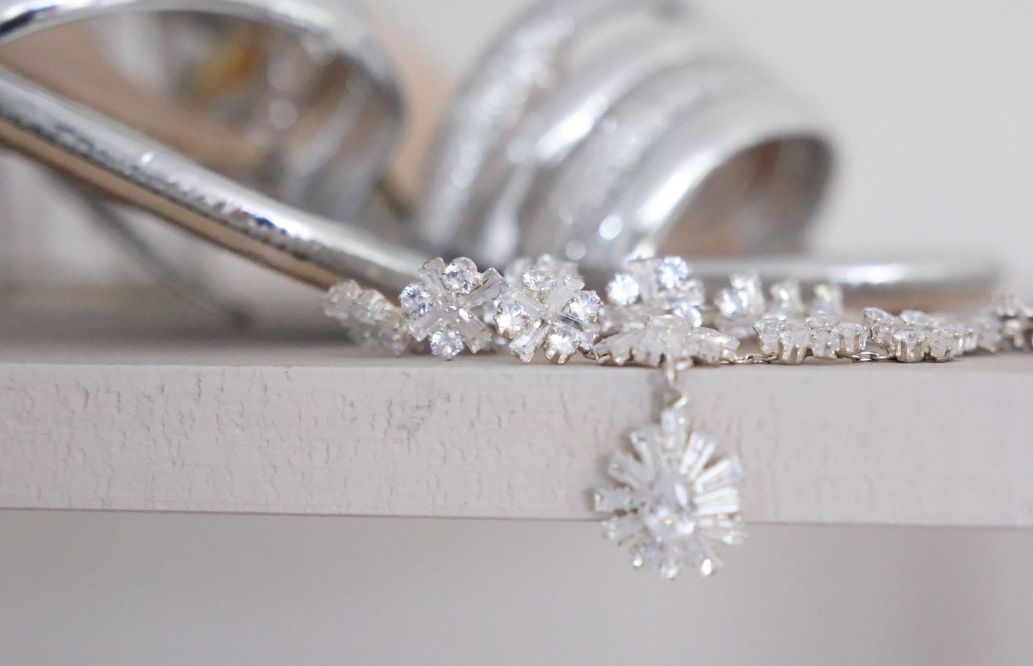 Close-up of delicate crystal wedding jewelry and accessories.