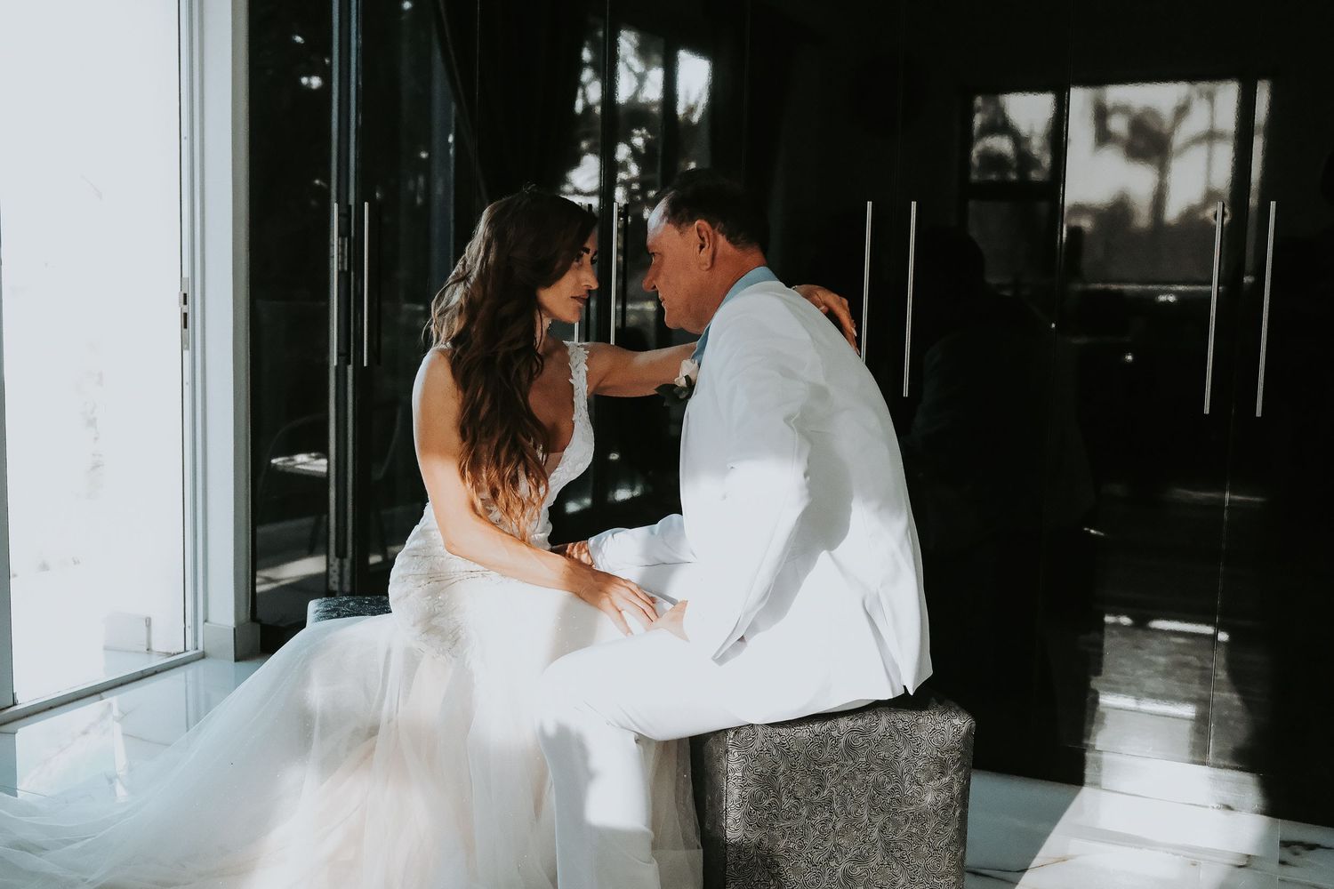 Wedding couple sharing intimate moment in black and white photography.