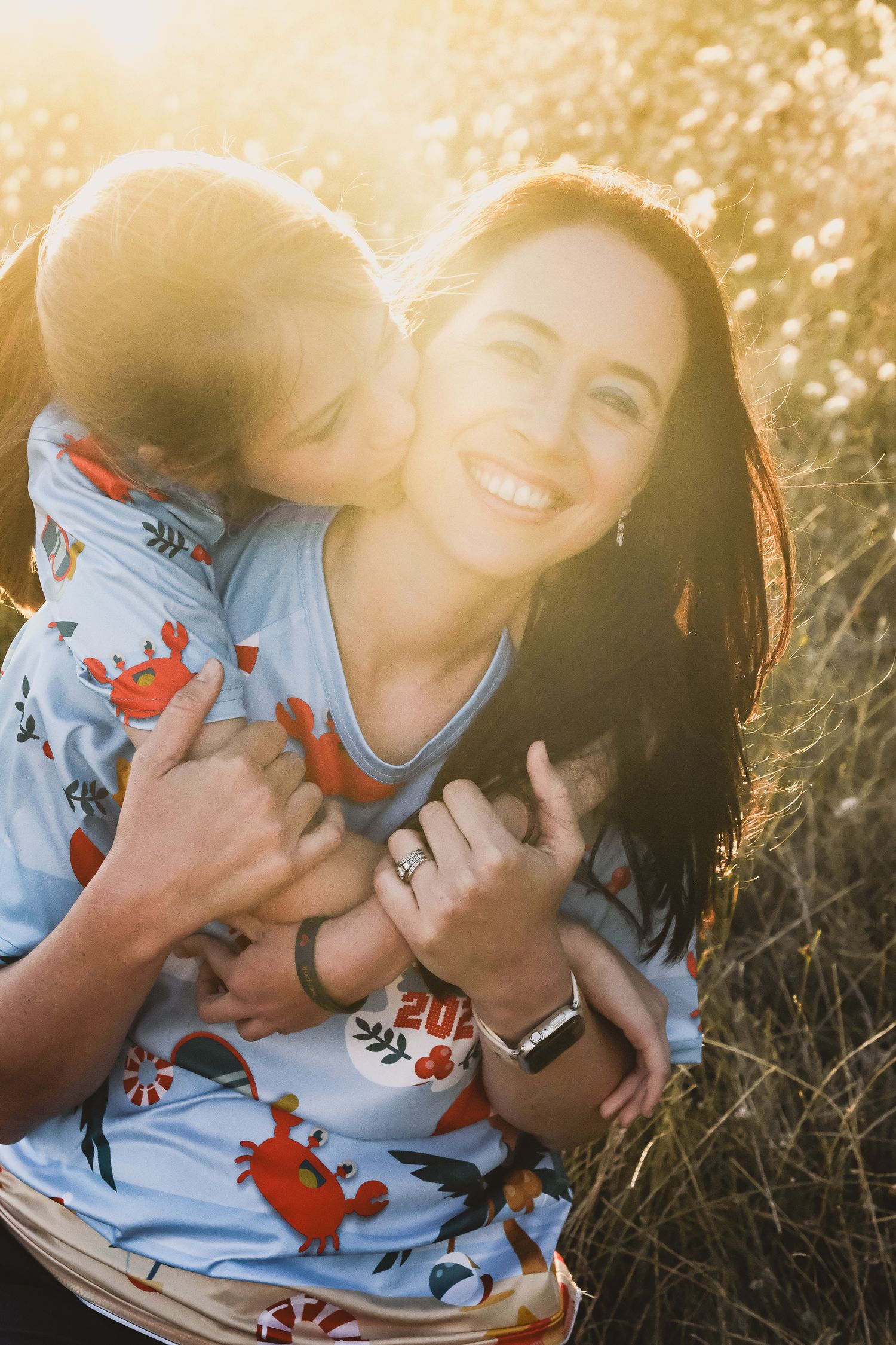 A joyful moment captured in golden sunlight with a small child in a patterned outfit.