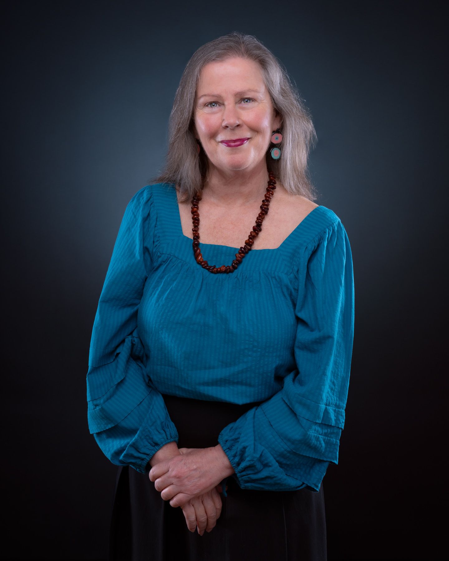 Professional portrait series showing a person in a bright blue blouse against a dark background.