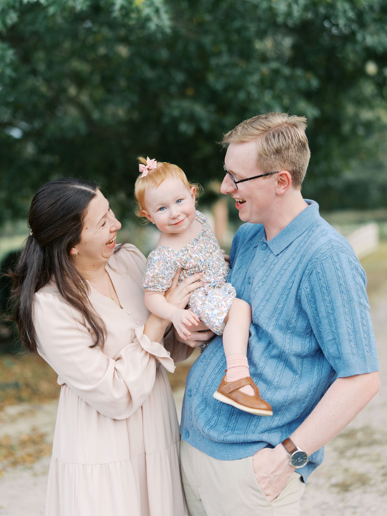 A family shares tender moments together outdoors in a series of candid photographs.