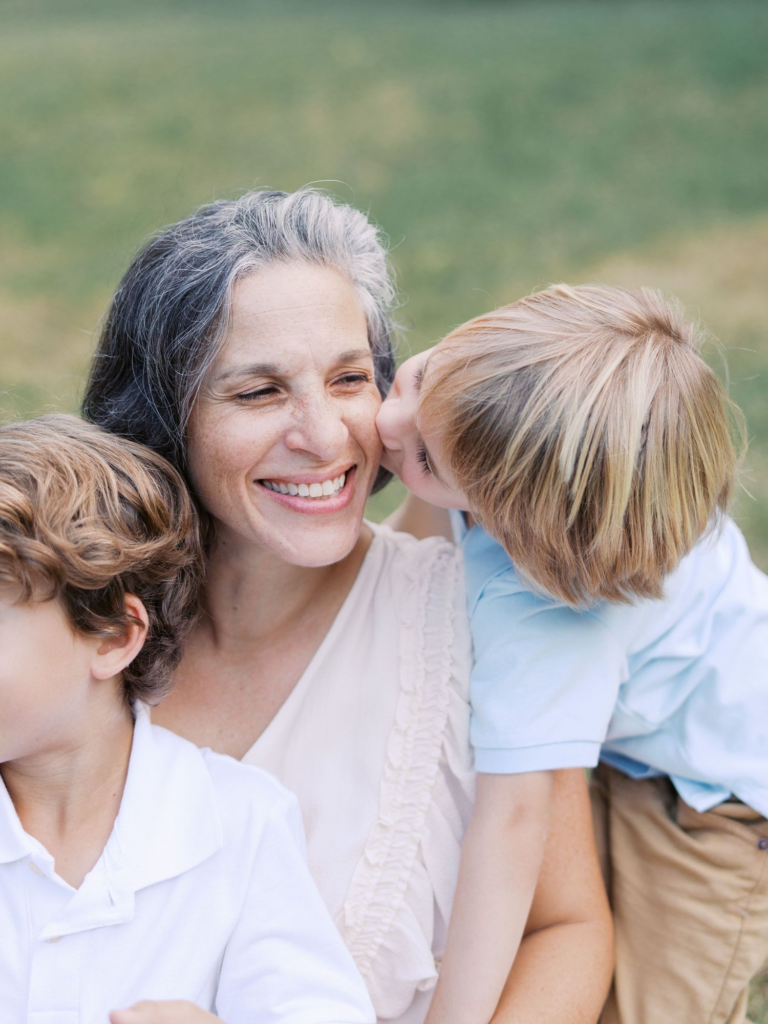 A tender moment between parent and child showing affection and love in an outdoor setting.